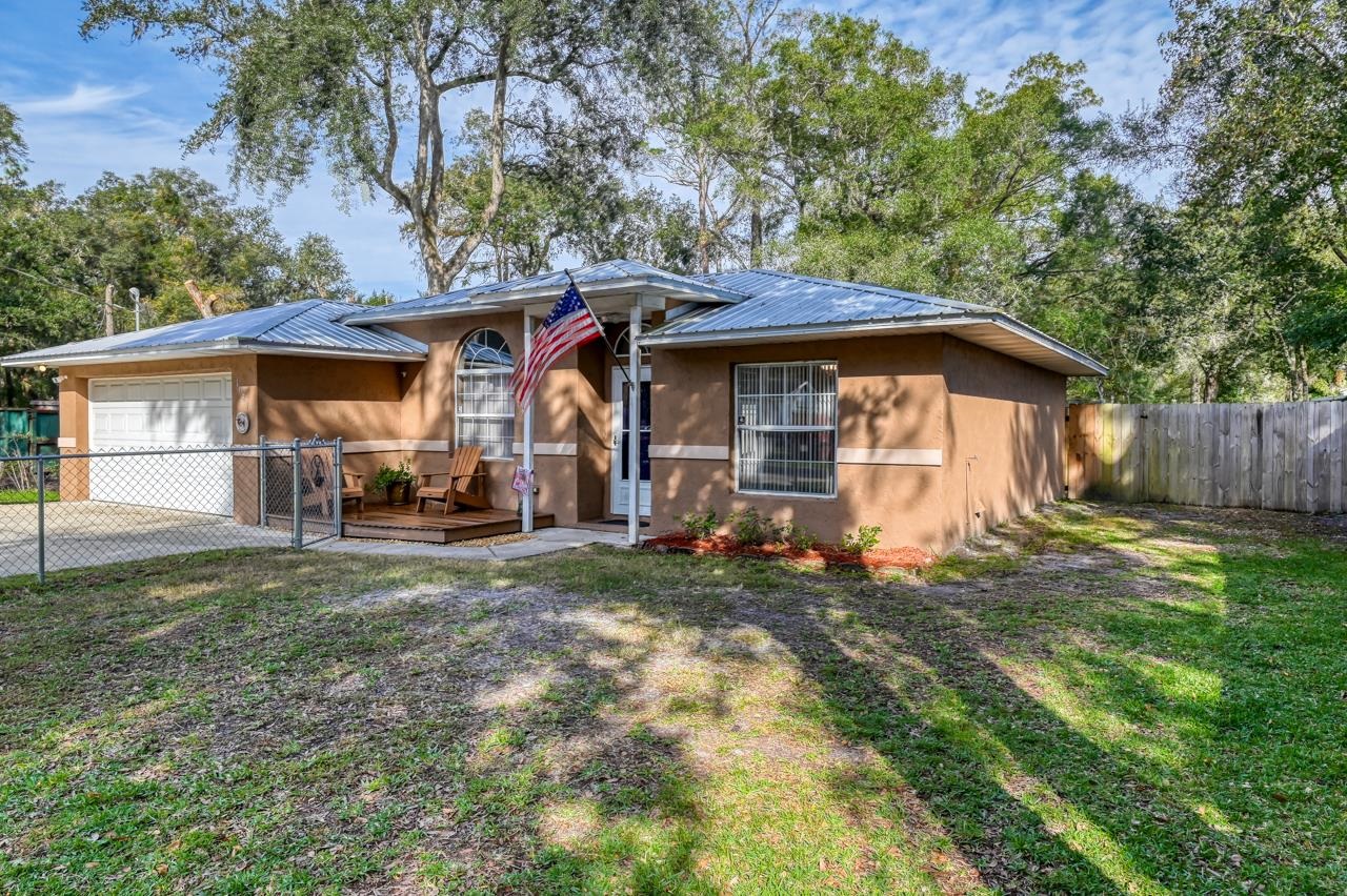 This concrete block home is located in a NO HOA community and settled on a high and dry lot. New roof in 2018, new A/C in 2016 & water heater replaced in 2021. Also replaced drain field, sump pump and septic tank pumped & inspected Aug 2019. Tile and laminate flooring throughout! Enjoy the screened in back porch and the fenced in yard. Well maintained and ready to move in! Close to grocery stores, gas stations, and Interstate 95.