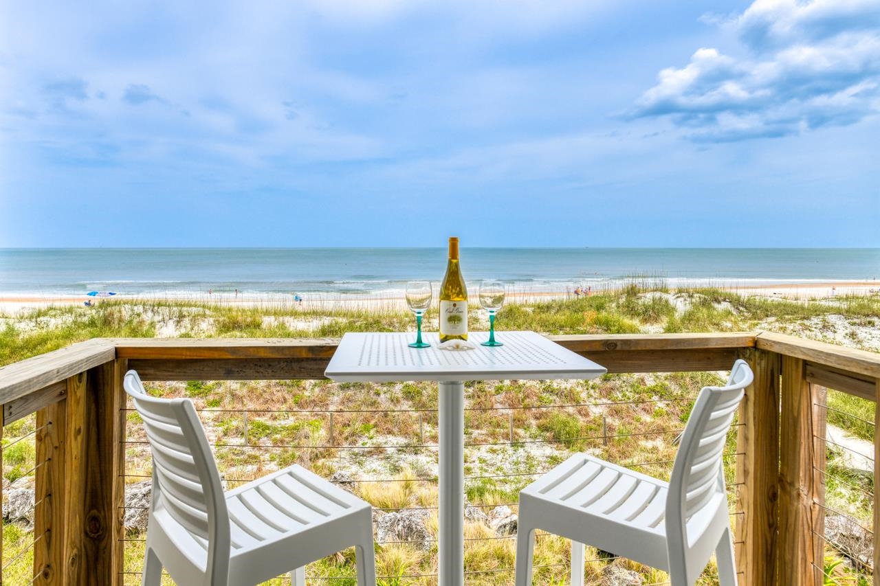Prepare to be amazed by the most incredible ocean views on St. Aug Beach.  As soon as you walk in the front door you will be drawn to the PANORAMIC OCEANFRONT WINDOWS (the entire back of the condo is windows & side windows too) Step through the slider to your OCEANFRONT PATIO and watch the waves!  When you turn around, you will find a COMPLETELY REMODELED – Ready to move into home.  Tile floors throughout, granite countertops, new cabinets, new impact windows, & beautifully upgraded bathrooms are just some of the upgrades done.    Up the tiled stairs, you’ll find the primary suite also has panoramic windows – so when you open your eyes in the AM you can watch the sunrise without even getting out of bed & watch the beach all day.  Enjoy your morning brew from the 3rd story private patio.  The 2nd bedroom also has triple windows looking South on St. Augustine’s powdery sand beach and catch the sunsets from the West facing window!