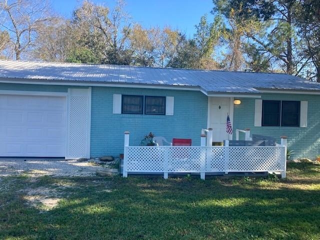 Updated 1,200 sq ft double wide mobile home plus 650 sq ft shop and garage with Snap-On tools, welding system, air compressor, air hose system for tools, drill press, chargers, 10' rolling work and welding table, pull-down stairs to attic with 400 sq ft floored storage area. 200-amp electrical system for shop tools LED lighting throughout, metal roof on two lots, fenced yard, multi-car, boat, RV storage. 8x10 concrete storage building with new metal roof. 3rd bedroom is extra large with full bath, private side & garage entry making it ideal for shared living or rental use! City water and septic system recently pumped and inspected. Property adjoins heavily commercial Hwy 207 properties, great for work from home skilled craftsmen, mechanics, artists, or wood workers. Minutes to Lowes, Home Depot, all restaurants, Winn-Dixie, hospital, new vet clinic, Publix, theatre.