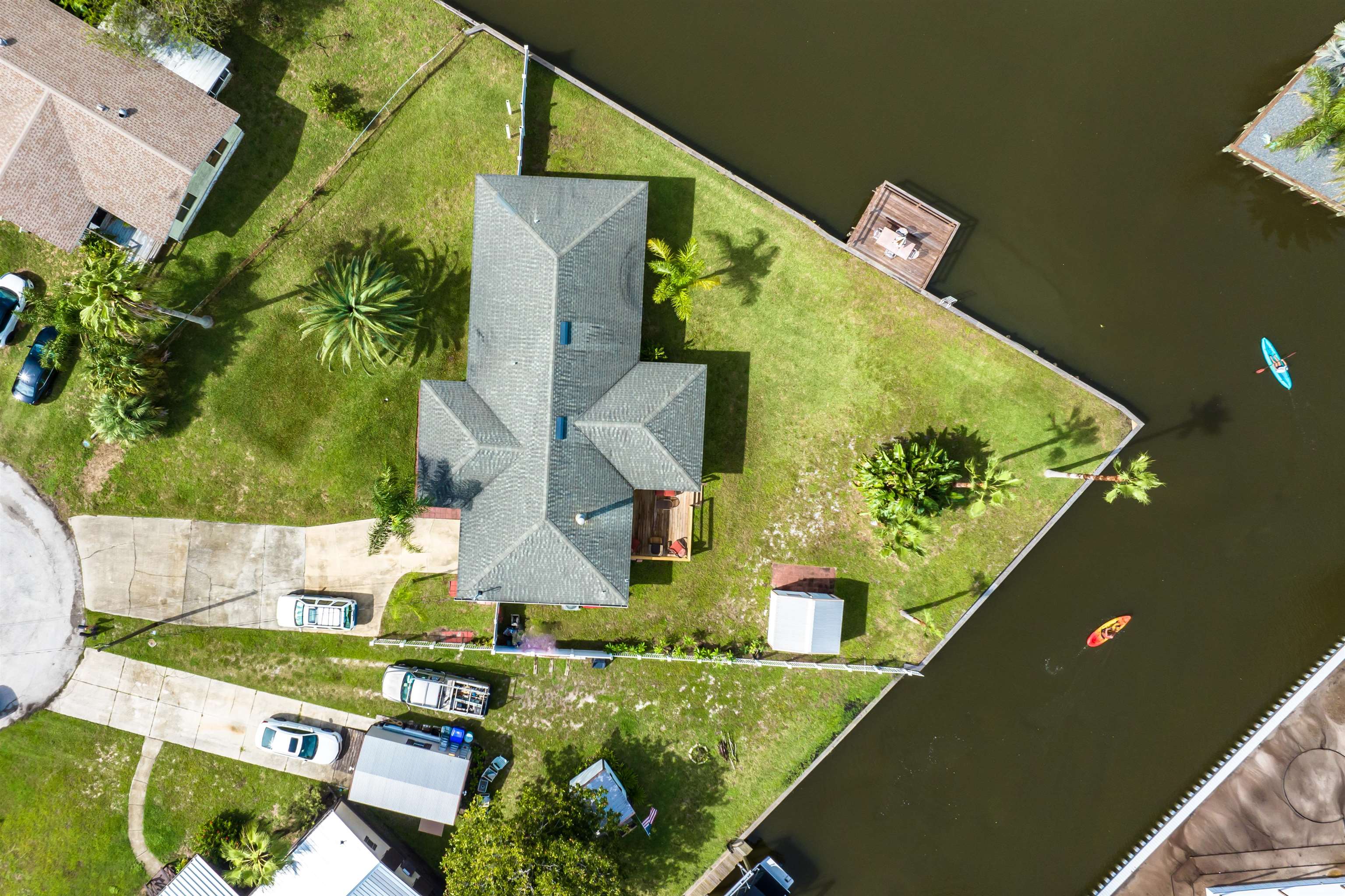 Welcome to your dream home in the coveted Treasure Beach community! This exquisite 3-bedroom, 2-bathroom gem boasts breathtaking Intracoastal Waterway views and sits on a generous waterfront lot, offering both privacy and endless potential. The heart of this property is its expansive backyard—perfect for creating your outdoor oasis. With ample space to build a pool and playground, you can design your ideal retreat right at home.  Step into the spacious living areas, where fresh, new paint and modern finishes create a bright and inviting atmosphere. The home features updated weather-stripping on all doors, ensuring energy efficiency and comfort year-round. A brand-new A/C system, installed in 2020 and maintained by All American Air, promises cool, refreshing relief during those warm coastal days. Imagine evenings spent enjoying stunning sunsets from your private waterfront deck, where the tranquil views and serene environment provide the perfect backdrop for relaxation!
