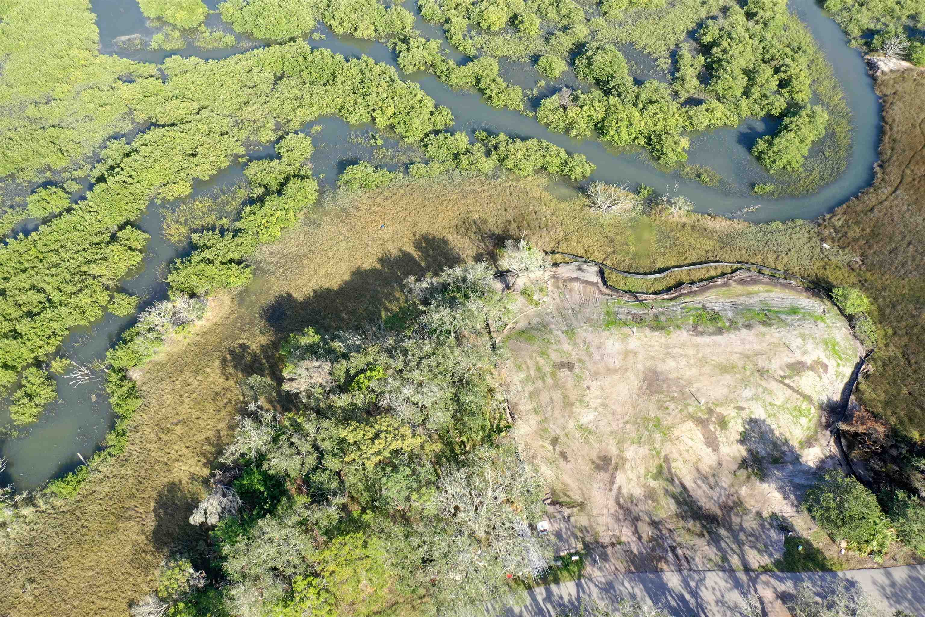This unique nearly 1 acre tidal creek lot in Yachtsman's Point at Pelican Reef has views all around and the added bonus of plenty of privacy. Lot price includes clearing, tree removal, appr 180 loads of dirt, soil compaction, engineering and soil boring tests. Lot is build ready and will eliminate the need for pilings. Custom designed ARB approved plans for a well thought out 5 bedroom/5.5ba home with full guest suite that has panoramic marsh and lighthouse views have been designed and are available to convey with the lot purchase. Save months of time on approvals and prep work and start building right away. The lot is just a few houses away from the 2024 HGTV Dream Home that was just completed. Purchase a boat slip with lift at the community marina on the intracoastal waterway and...