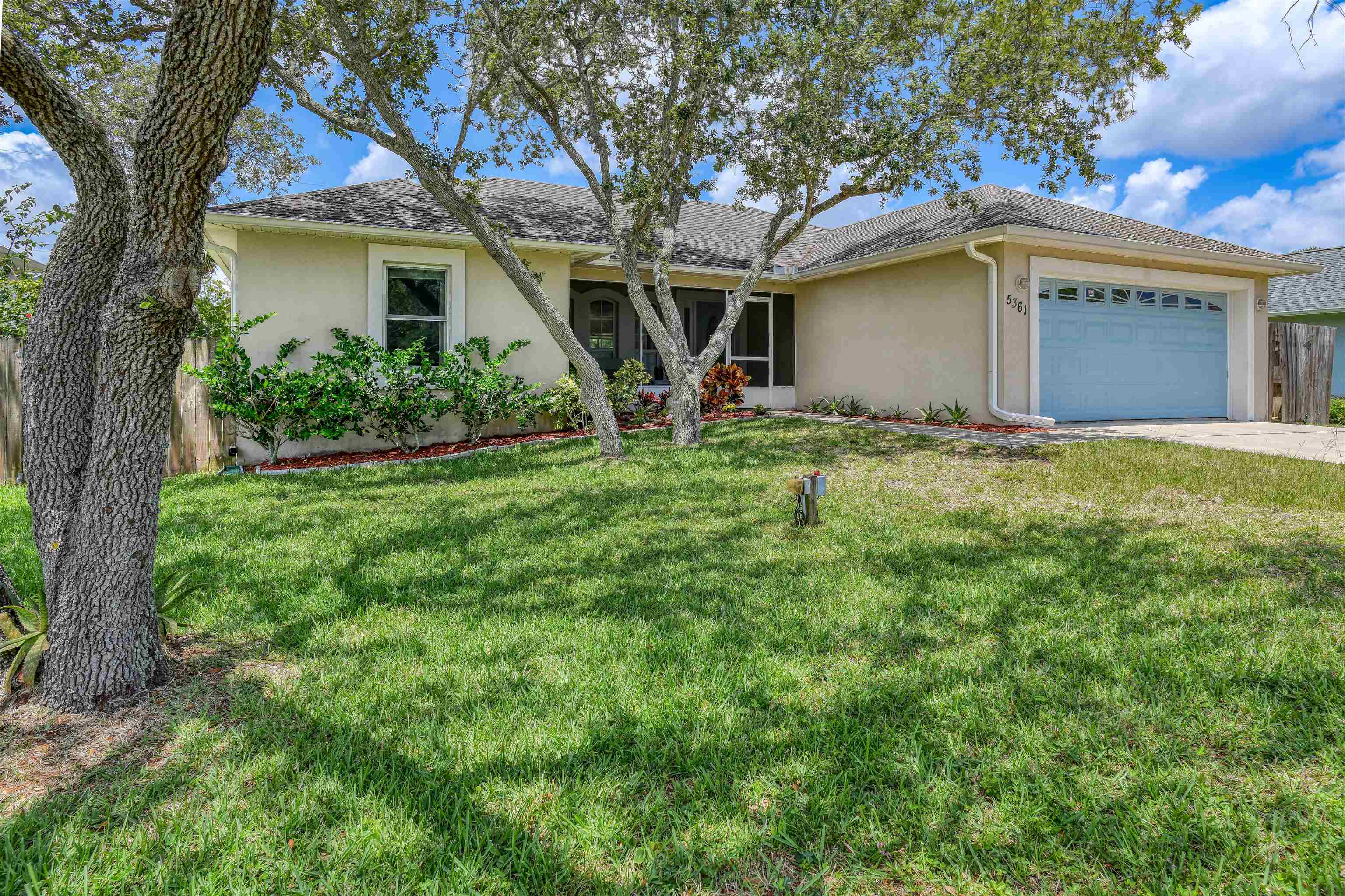 Anastasia Island: Easy walk to beach or Intracoastal! Brand new roof, two-car garage, concrete construction, high elevation! Windswept Acres is the perfect place to call home, also ideal for second home or vacation rental. Delightful family neighborhood with no HOA, perfect for bike-riding and dog-walking. Three-bedroom split plan with two full baths, tile floors. High ceilings, lots of light, and an open, spacious living area. Screened-in front porch overlooks mature live oaks. Plenty of room for an in-ground pool (ask your realtor for details on local cost to install). Fenced-in yard and covered back porch for outdoor living--BBQs and family fun in a private oasis. Lots of tasteful details, including plenty of closet space, working fireplace, top-of-the-line window blinds, outdoor hot-water shower, water softener, and reverse-osmosis drinking water. County water and sewer and NO FLOOD HISTORY.  Make an appointment today; this is a must-see!