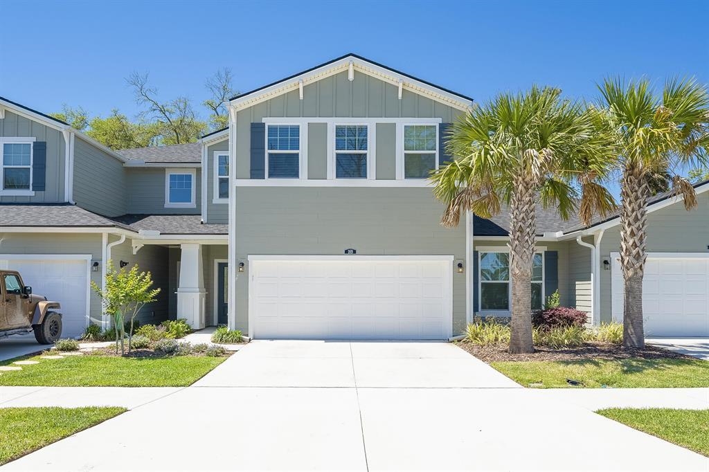 Welcome to the Coral floor plan with 3 bedrooms, 2.5 baths, an upstairs den and 2 car garage, the largest floorplan available in Antigua on Anastasia Island. This townhome has an amazing spacious back view overlooking an ancient live oak and expansive lawn area much like a single family home without the upkeep. Bright and open with a large kitchen island it offers the perfect layout. These newer maintenance free town homes are within two miles of the beach and just minutes away from area attractions, dining, medical facilities, restaurants, shopping and more. Enjoy intracoastal views of Downtown St. Augustine, the Bridge of Lions and waterways. Spend weekends at the amenity center featuring a covered entertainment area with tables, a fire pit, swimming pool and boat dock where you can launch your canoe or kayak in the wide tidal creek leading to the intracoastal waterway. Antigua even has storage racks for your kayaks, etc. The neighborhood