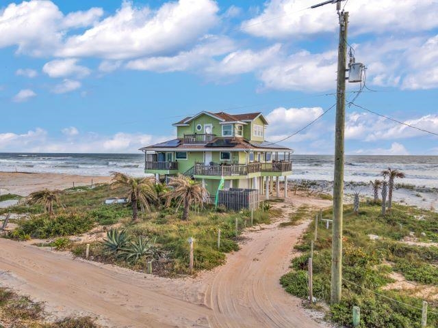 Welcome to this exceptionally maintained, 3-bedroom, 2-bath Key West-style home in the exclusive seaside enclave of Summer Haven, a private beachside community. This direct Atlantic Oceanfront property offers the rare combination of ocean and river frontage, providing awe-inspiring views in every direction. Set on a private road with no drive-on beach access, this home offers peace, privacy, and the timeless charm of Florida’s most scenic stretch of coastline. A sweeping wrap-around porch invites you to relax and savor the breathtaking sunrises over the Atlantic and glowing sunsets over the Summer Haven River—the ultimate in coastal living. Meticulously cared for by its current owners, this residence is move-in ready with premium upgrades throughout including a solar system with 6 power cells, an inverter, and FPL's net metering system, hurricane impact windows, and garage parking!