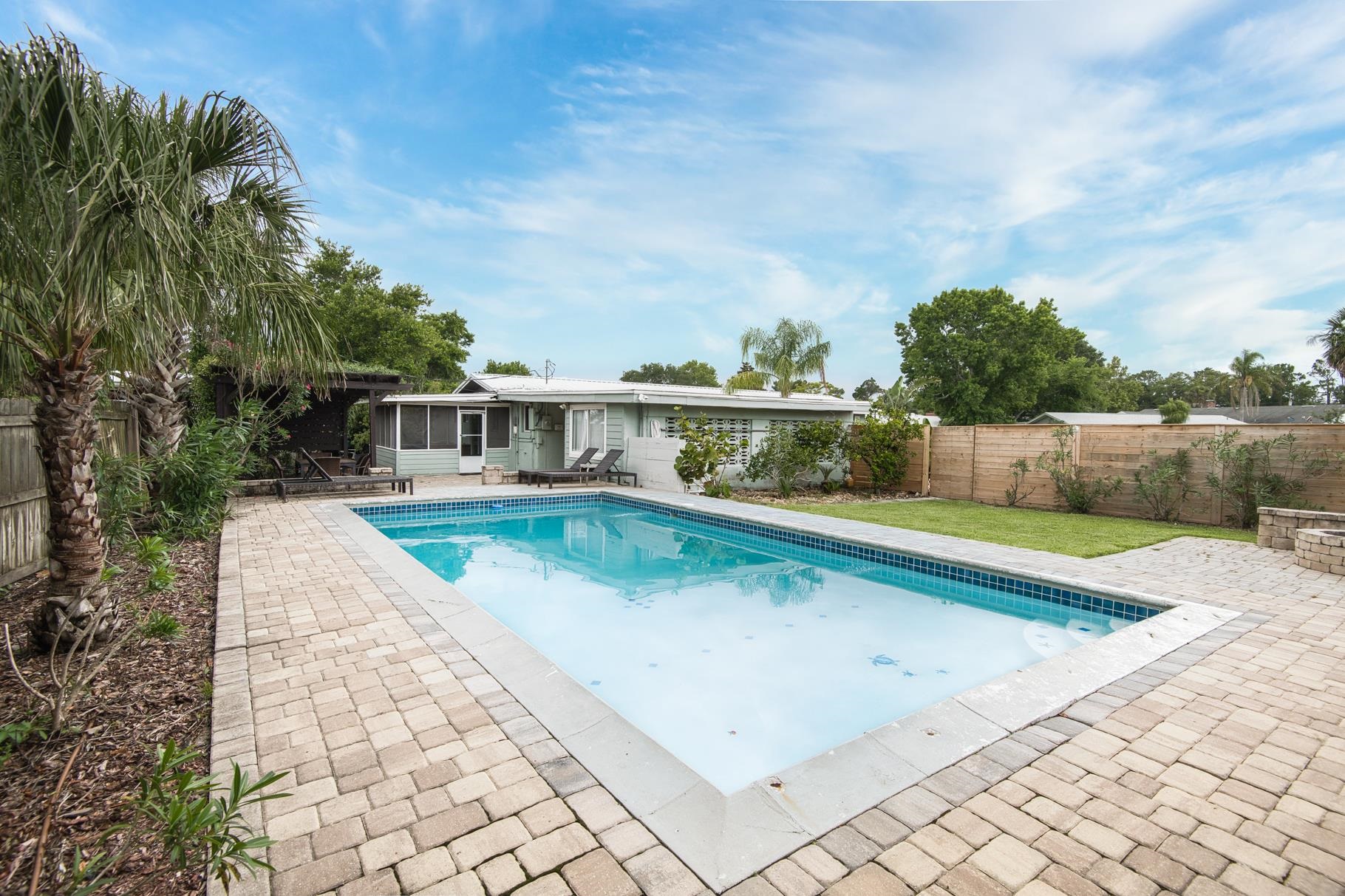 Welcome to this beautiful 4-bedroom, 2-bath home located in the desirable Surfwood neighborhood on Anastasia Island. Ideally situated just minutes from the beach, pier, and only 5 minutes from historic downtown St. Augustine, this property offers the best of coastal living and convenience. The backyard is a private oasis, featuring a heated pool, fire pit, full fencing, and a screened-in porch — perfect for year-round outdoor enjoyment. Inside, the updated kitchen boasts granite countertops and stainless steel appliances. Currently part of a successful vacation rental program, this home is an excellent opportunity for full-time living, a second home, or an income-producing property. Don’t miss your chance to own this ideal beach retreat!