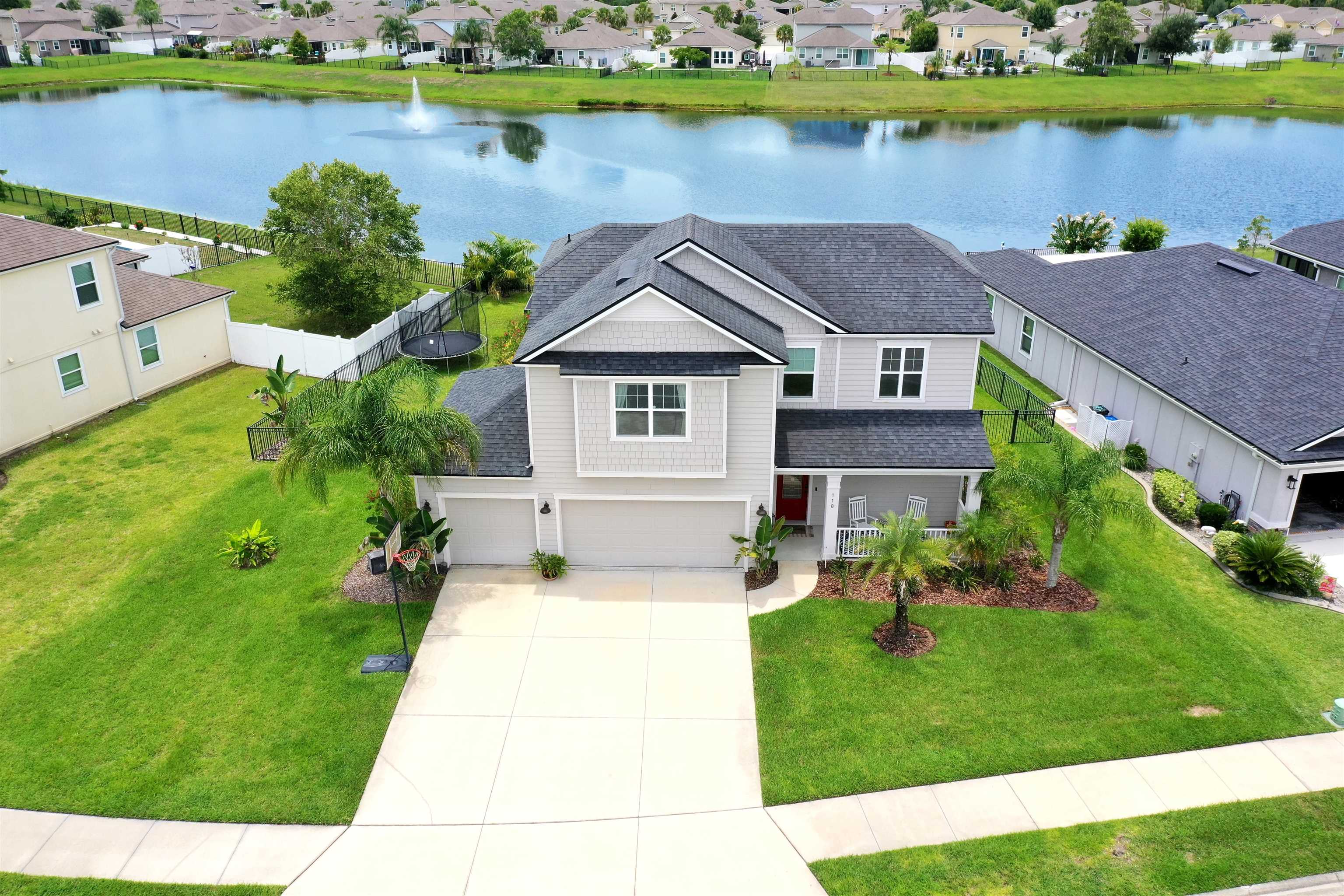 Andalusia pool home with expansive lake and fountain views has it all and offers many options for your living needs. A large screened in heated saltwater pool and spa and a covered lanai flow seamlessly from your open concept great room/dining and kitchen for the best in indoor to outdoor living. This 4 bdr, 2.5 ba with primary on the main also has an upstairs extra spacious bonus area for secondary living. The primary has a barn door, large owners bath with a separate tub and shower, dual shower heads and an oversized walk in closet. Updated light fixtures throughout, custom kitchen vent hood and a water softener are just some of the upgrades to the open living floor plan. A 3 car garage, fully fenced yard, lush landscaping and a well for irrigation round out the well thought out details. Perfect for family life, the community has a pool, clubhouse, exercise facility, 3 playgrounds and a fairy garden along with being adjacent to Treaty Park and all of the recreational activities