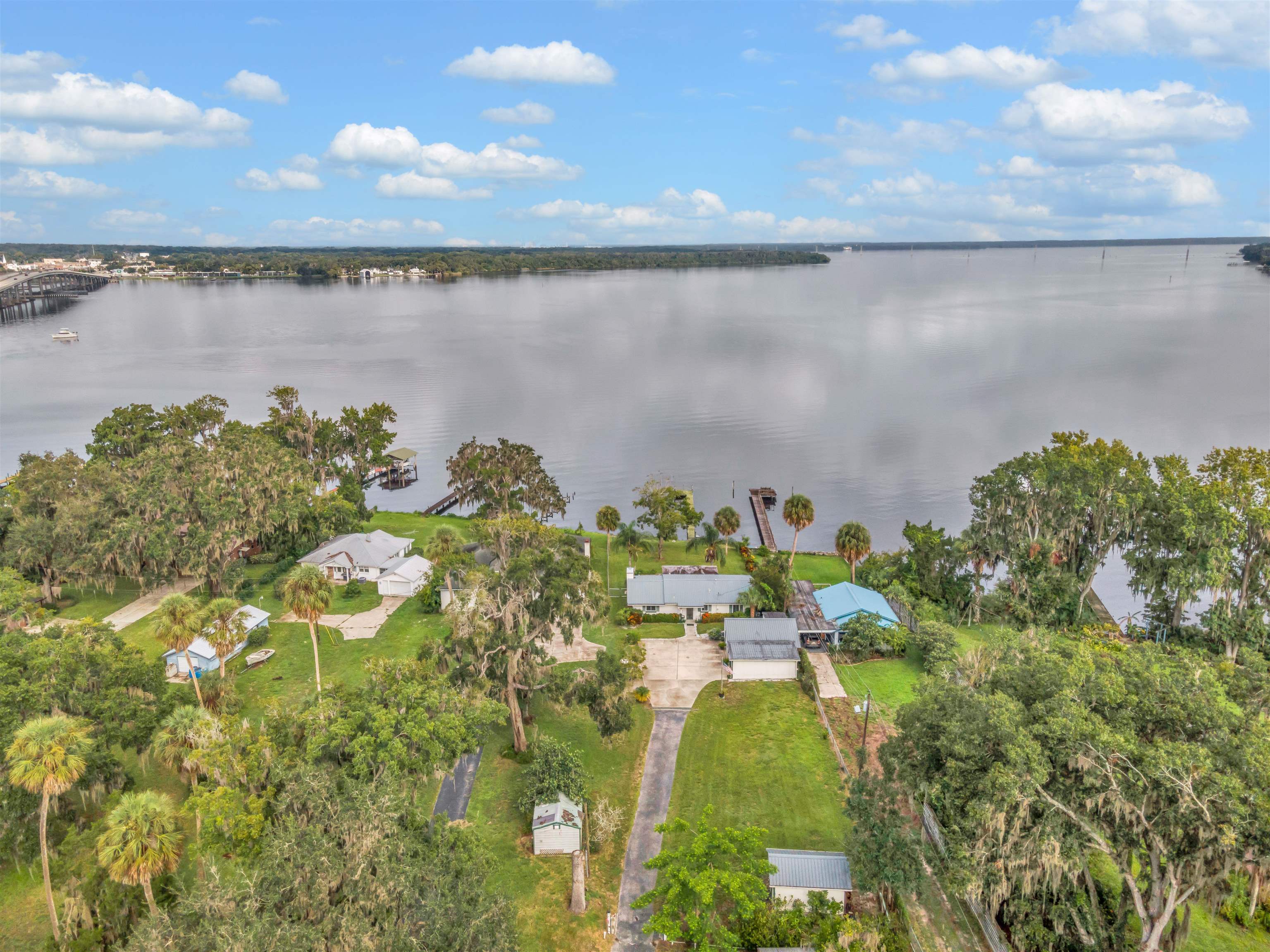 Riverfront Retreat with Expansive Views & Timeless Charm – East Palatka, FL Welcome to Sunset Point A Perfectly Named  private paradise on the majestic St. Johns River, where golden sunsets cast a warm glow across the water and serenity meets convenience. This beautifully maintained concrete block home offers unobstructed panoramic views from nearly every room—including the inviting Florida room, perfect for morning coffee or evening relaxation. Inside, you’ll find a thoughtfully updated kitchen and modernized baths, blending comfort with style. The cozy living room features a classic brick fireplace, adding warmth and charm to your evenings.Outside, enjoy expansive river views from your own private dock. Storage Galore include detached 2-car garage with an additional workshop space—ideal for hobbies, storage, or creative projects. Located in peaceful East Palatka, just a short drive to historic St. Augustine, this home offers the best of both worlds: privacy, nature, and convenience.