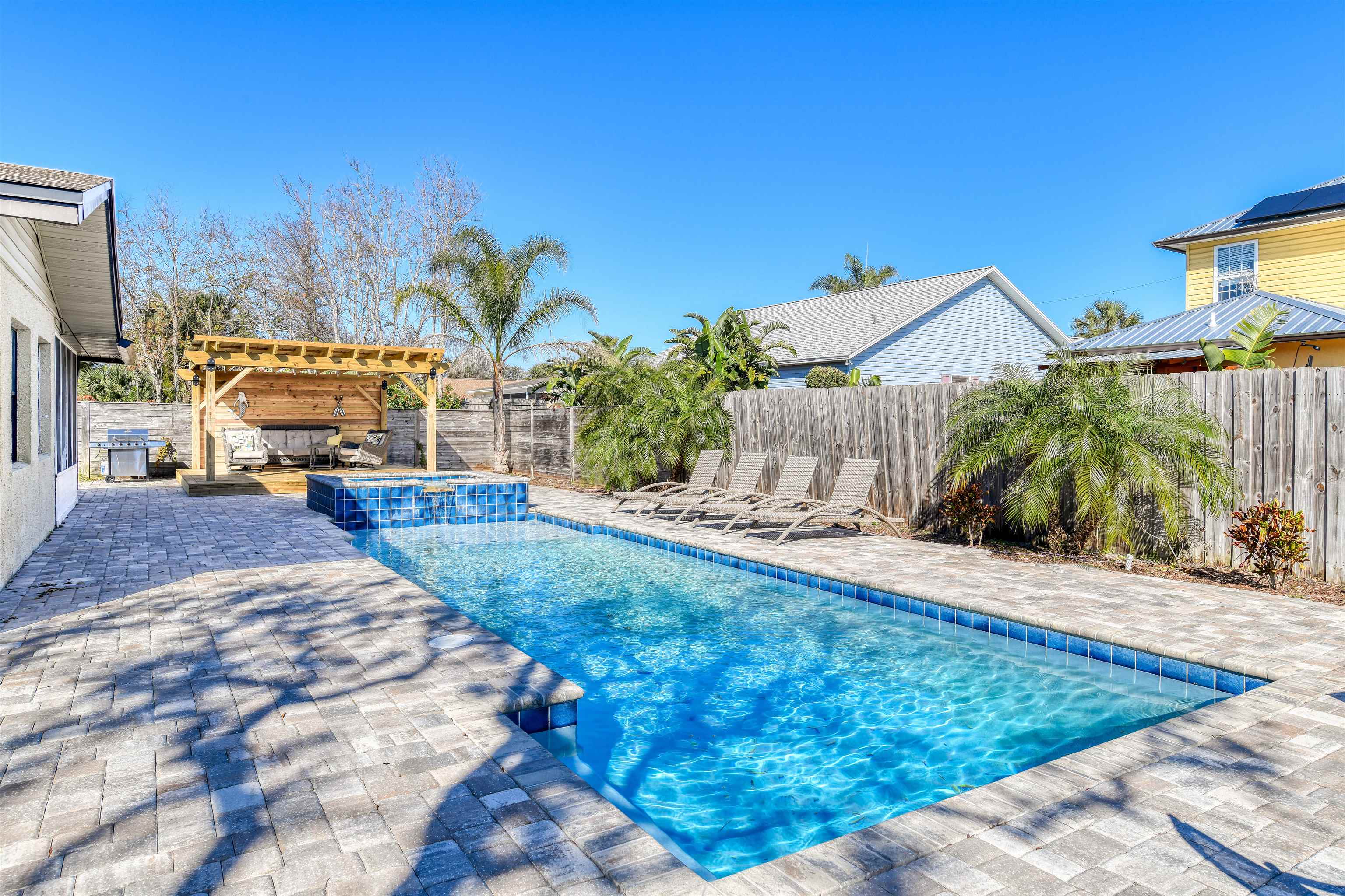 Welcome to this beautifully updated beach home in the highly sought-after Mickler's Subdivision, just a short 6-minute walk to the beach and boat ramp access! Perfect for beach and nature lovers, this property offers a perfect blend of comfort, style, and relaxation. Step inside to discover a completely remodeled kitchen featuring sleek stainless steel appliances, ample counter space, and modern finishes that make cooking a pleasure. The spacious floor plan includes 4 generously sized bedrooms, ideal for family or guests, 2 beautifully remodeled bathrooms, and a flex room that can serve as a home office, playroom, or additional living space. Set on a large lot, this property doubles as a private backyard oasis with a sleek heated pool and spa, a cozy firepit, and a covered gazebo perfect for entertaining. Beyond its charm as a primary residence or vacation getaway, this home is also a very successful vacation rental—offering not only lifestyle but investment potential!