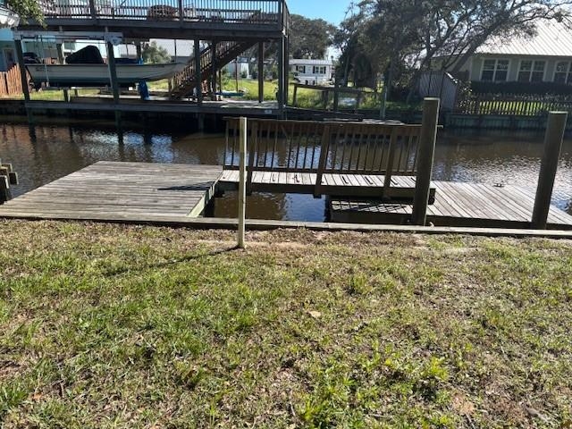 Live the waterfront lifestyle you’ve been dreaming of. This canal front property in Treasure Beach offers salt water access tot he intercoastal, mature live oaks, a dock side gazebo, and a bulkheaded shoreline. The existing 1975 singlewide mobile home (with additions) represents an optional starting point—fix it up for now, or clear the way for your dream house. All this just five minutes’ walk from the ocean. Perfect for fishermen, nature lovers, or anyone craving peace and beauty at the water’s edge. This is being sold As-Is where is, cash only.