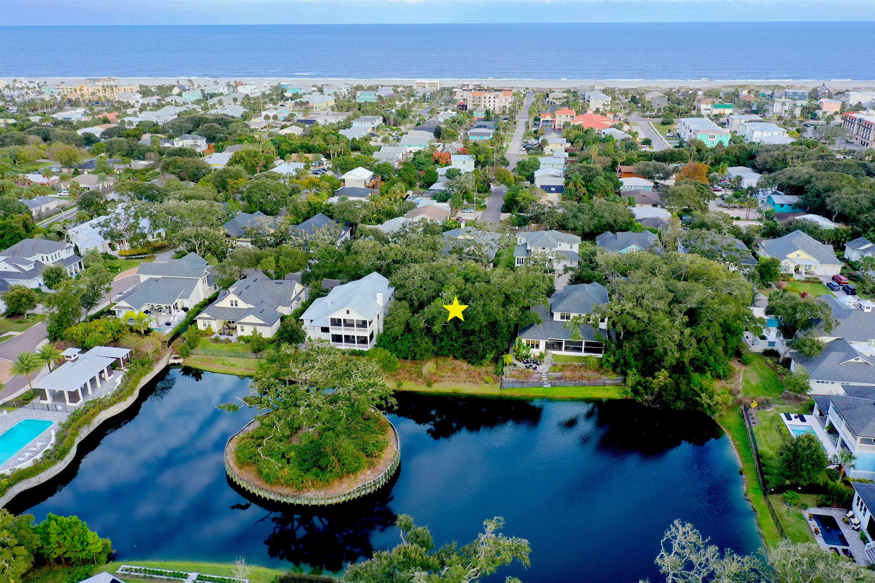 Rare opportunity to build in coveted Ocean Ridge in St. Augustine Beach on this very high and dry lot backing to the pond. There is a reason it is called Ocean Ridge and this lot is high on the ridge. Nestled in between two beautiful homes and overlooking the water, beautiful sunsets and the small island displaying the majestic oak you can build a truly remarkable home on this hard to duplicate lot. Listen to the sound of the Ocean from your porches. Take a short walk from the community path down one of the quaint side streets to the nearby beach walkover that leads to the non driving portion of St. Augustine Beach. Relax at the community pool and cabana house or bike to shops, restaurants and the Wednesday farmers market. Walk to the fireworks at the pier on New Years Eve. The neighborhood was developed by McGarvey Residential and is among the most sought after in the desirable golden triangle of St. Augustine Beach.