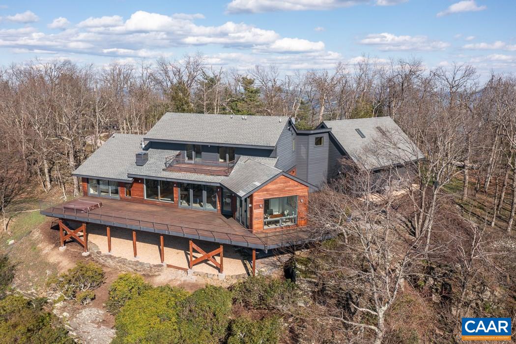 One of a kind Ridge Top home, with above the cloud living! Breathtaking views of the Blue Ridge National Park, Shenandoah Valley, and the Alleghany Mountains that will leave you awestruck. Meticulously architect-redesigned and renovated in 2014, gutted to the studs and completely rebuilt with impeccable taste, craftsmanship and longevity in mind. The home boasts White oak flooring throughout the main living area, walnut cabinetry in the kitchen and Great Room. Cambria quartzite countertops and steel and stone accents, highlighting the Great Room gas fireplace. Main level Master suite offers a luxurious soaking tub, separate glass shower enclosure, walk in closet, gas fireplace and of course-the views! Two large bedrooms on the second level, with huge bonus room above the 3-car garage. Expansive wrap deck around the ridge side to enjoy the incredible sunsets. Exterior is sleek and modern with IPE wood accents that accentuate the mid-century modern vibe of the entire property. Featured in Abode Magazine, ask for details. This is one home not to be missed, and will impress at every turn. AGENTS PLEASE SEE showing instructions in Agent Remarks. Thank you for looking!