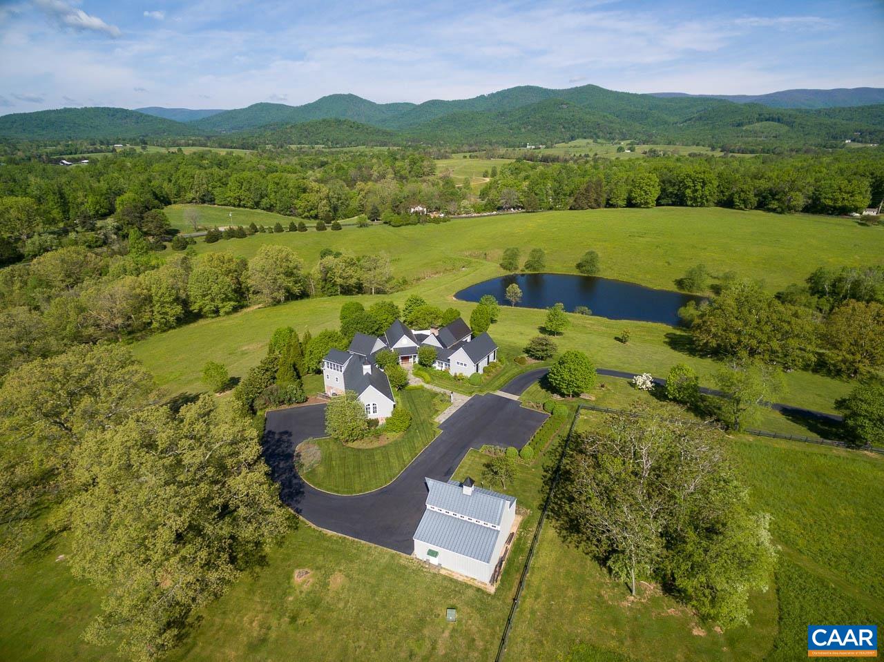 Grey Oaks - a spectacular country estate offering total privacy from over 53 pristine acres in Free Union. Three parcels of gently rolling land, mostly open w/streams, lush meadows, majestic oak trees, Blue Ridge views and two ponds (one is approx. 2 acres). The heart of the property showcases a stunning custom-designed residence, built by Shelter Associates, w/6 BR (one currently serves as an office), 6.5 BA, spacious chef's kitchen w/center-island, lovely dining room and breakfast room, cozy paneled den, and great room w/soaring exposed-beam ceiling and fireplace. The vaulted entry foyer is flanked by two light-filled gallery halls; one providing access to the luxurious master bedroom suite and the second leading to guest/in-law/teenager living quarters comprised of 3 BR, 3 BA, a full kitchen, dining area, and a loft/family room w/fireplace. Superior finishes, details and craftsmanship inside and out; floor-to-ceiling windows, hardwood and limestone flooring, built-ins, extensive decking and porches, just to name a few! 3-bay attached garage, 1-bay attached garage, ample storage, and a 1,800± sf  barn. Property is not under conservation easement. Located approximately 15 miles NW of UVA and Downtown Charlottesville.
