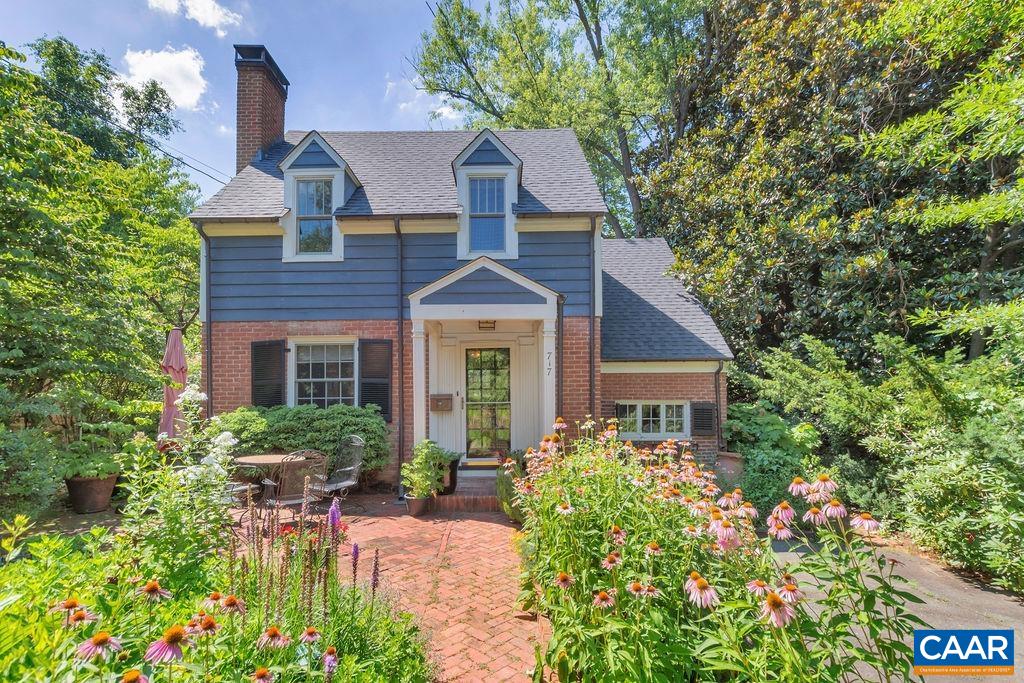 This special NORTH DOWNTOWN property features a winsome c. 1941 cottage + newer detached 16x32 STUDIO/workshop set amidst a quarter-acre oasis of beautifully LANDSCAPED lawn + gardens, only 15 min stroll to the vibrant Downtown Mall. Curb appeal abounds: exquisite cottage gardens (native plants, hummingbirds) + charming brick patio greet you from a quiet residential lane among character-rich homes that have been lovingly expanded as this one could be. Light streams in the glass-front door to an opened-up living room w/built-in shelves + wood-burning fireplace. The floorplan delights w/ many sweet surprises inc. nooks + series of steps leading you to rooms such as the vaulted dining room overlooking private backyard gardens, patio + stone wall or the kitchen feat. gourmet appliances, high beadboard ceilings, recessed lights + large window. Upstairs, 3 bedrooms + full bath (half bath in the basement). Elevated at the back of the lot + easily accessed from a city alley is a fantastic accessory building w/ SO MUCH POTENTIAL (think guesthouse, office, gym, workshop). Current owners have made many improvements inc. new roof (2021), A/C heat pump (2021), water heater (2019), blown-in insulation.