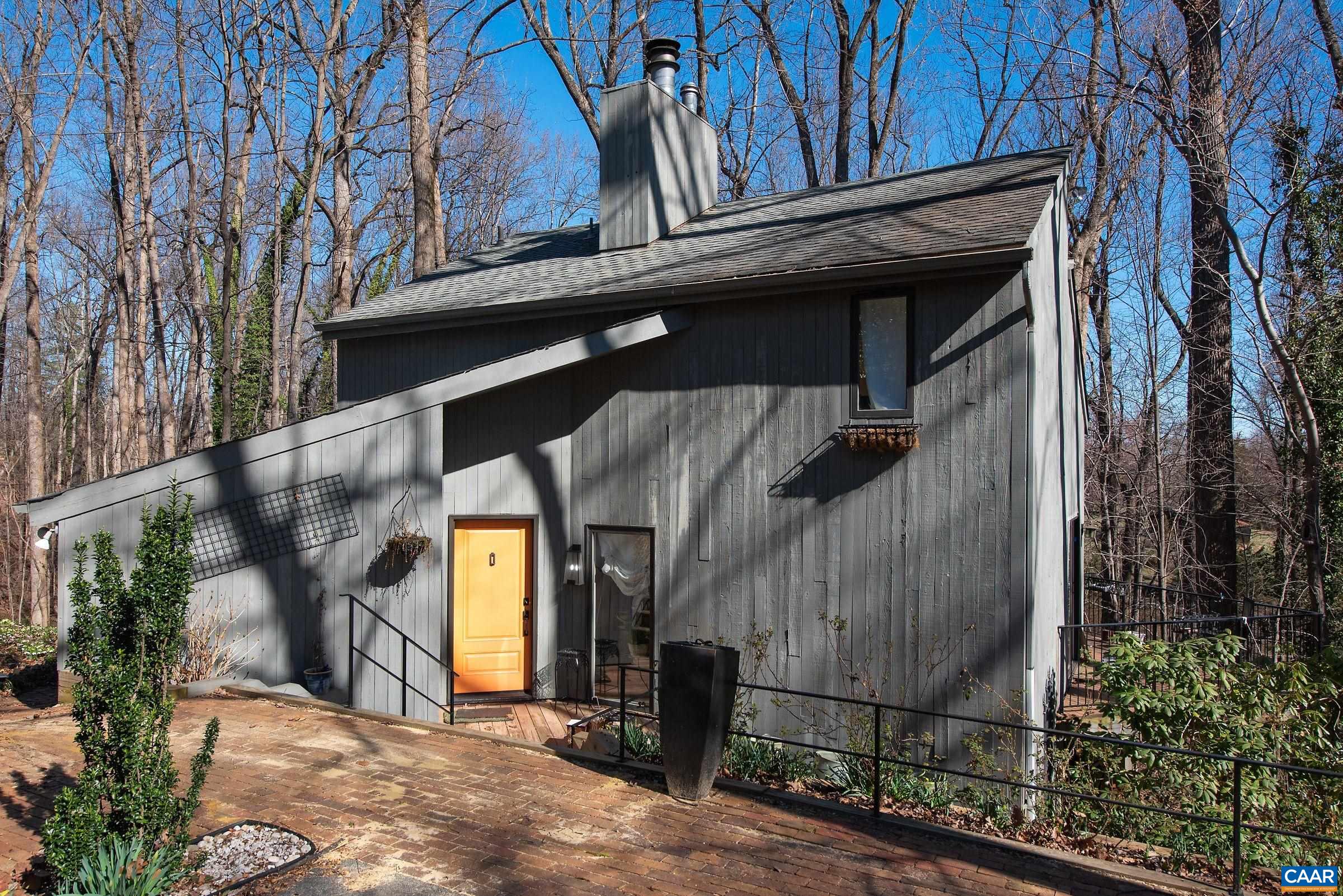CHARMING, LIGHT-FILLED CONTEMPORARY HOME SET ON 2.6 WOODED ACRES... MASONERY FIREPLACE, BUILT-IN BOOKCASES, VAULTED CEILING, FRONT BRICK TERRACE, REAR AND SIDE DECKS....GREAT FOR BIRDWATCHING...THREE BEDROOMS AND THREE FULL BATHS...INCLUDING AN IN-LAW SUITE ON THE TERRACE LEVEL....