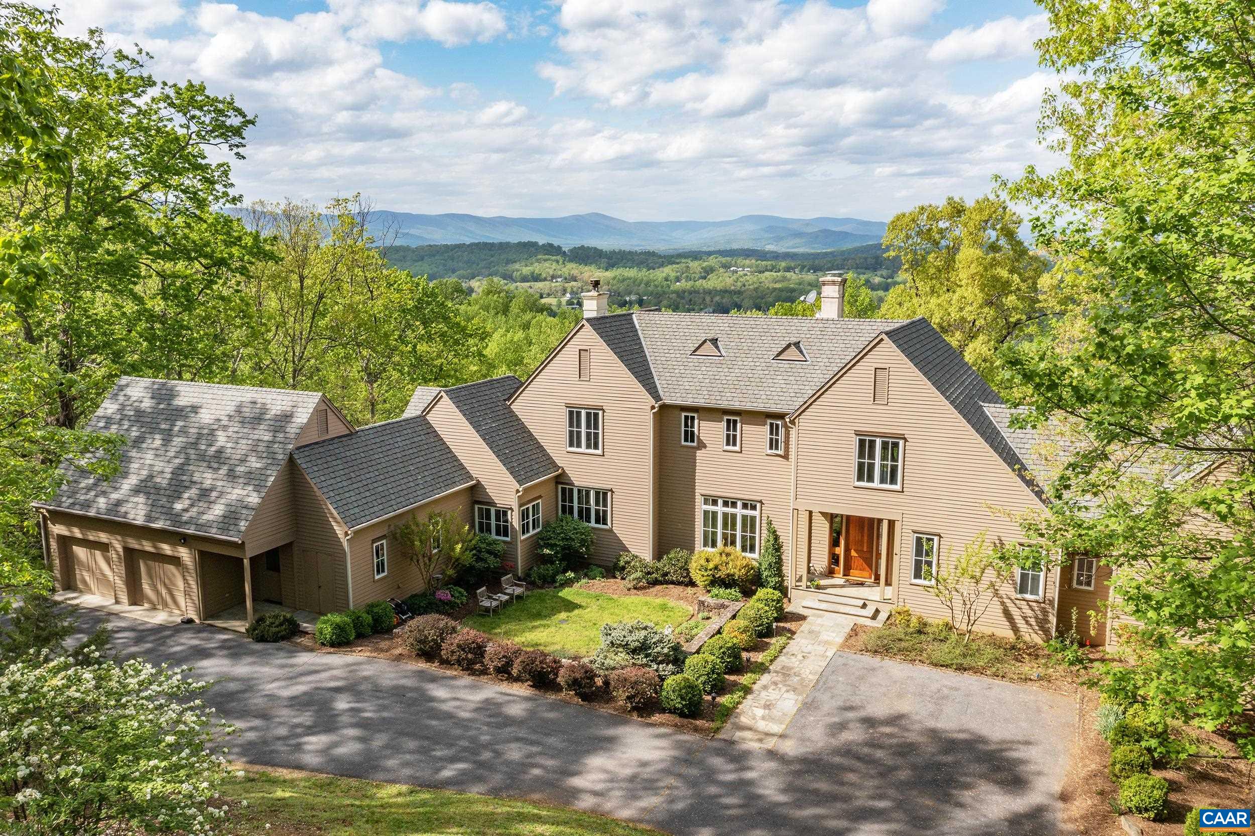 Panoramic views of the Blue Ridge Mountains & Albemarle County - all the way into Greene County from 1,000 ft. elevation - in the coveted Rosemont neighborhood - less than 15 minutes to UVA & Charlottesville. Dramatic residence with over 5,000 fin.sq.ft. has been very well maintained and includes new HVAC, new water heaters & new appliances. Entire exterior just painted. Interior features: a main level master suite; home office; 10 ft. ceilings; beautiful heart pine floors; well-equipped kitchen with white cabinets and a beautiful granite; adjoining breakfast room with stone fireplace that flows out to a screened porch and spacious open deck to enjoy the SPECTACULAR VIEWS! There are two more levels - two bedrooms and hall bath on the second level, and a walkout terrace level that includes a 4th bedroom, full bath, exercise room, utility & storage. The property contains over 11 acres, mostly wooded with a stream. This is a special offering situated in the Ragged Mountains with magnificent views, privacy & tranquility.