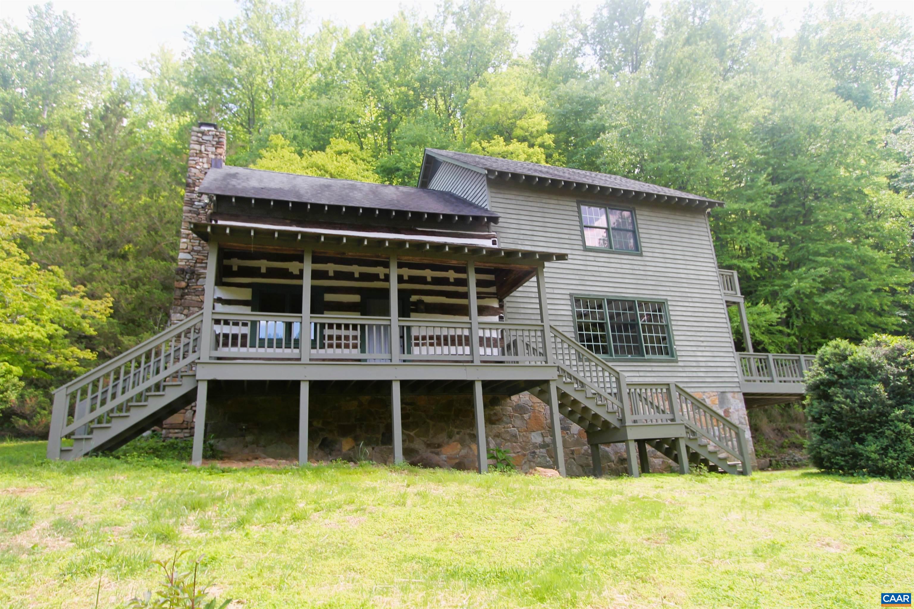 A Nelson County Gem!  This unique recently Updated and Freshly Painted 3 Bedroom 2 1/2 Bath Home is waiting for you. Sassafras Farm consists of 74.5 acres, a 200 year old chestnut log cabin was tastefully integrated into a two story farmhouse built in 1990.  Walk into the Living Room and see the beautiful Stone Hearth and add your own Wood Stove.  Bright New Kitchen with Exposed Beams include white granite Counters, SS Appliances and Range Hood, new cabinets and flooring.  Original cabin exposed walls and beams extend through out the House.  Laundry Room with new Tile Flooring.  Extensive stonework, multiple porches and decks, dramatic views.  2-Stall Horse Barn.
