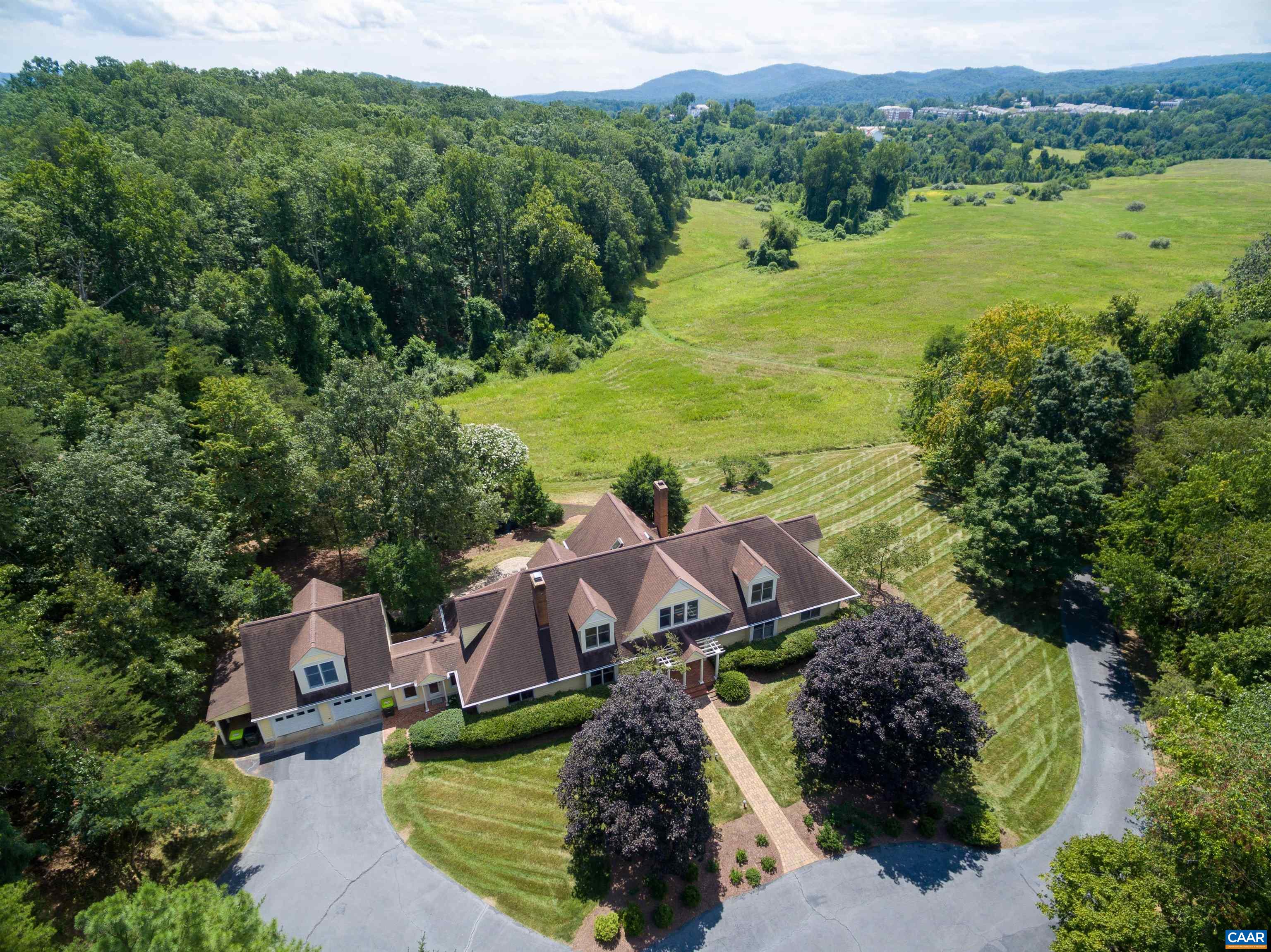 This captivating property, nestled on a private 3.28 acres, offers a harmonious blend of luxurious design & idyllic natural surroundings. The 1st-floor master suite offers picturesque views of a rolling pastoral field that stretches towards beautiful mountains. A gourmet kitchen features sleek countertops, abundant cabinetry,  stainless appliances & a cozy breakfast area. A family room, study, three additional bedrooms & an-over-the-garage office make this a versatile floor plan. The heart of the home is the living room, where comfort meets grandeur. Soaring ceilings create an airy ambiance, inviting abundant natural light for hosting a gathering or enjoying a quiet evening by the fireplace. See the list of many improvements/upgrades in the documents section. You'll enjoy a sense of community and access to Charlottesville’s best that cater to every facet of your lifestyle, whether it's leisurely strolls along scenic streets, a quick trip to the nearby farmer’s market, or many restaurants & shops.