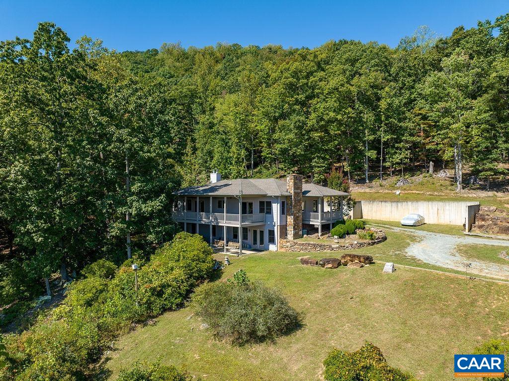 CUSTOM-BUILT BUTLER MOUNTAIN HOME-RETREAT ON 82 ACRES - Schuyler, Nelson County -500 COSBY HOLLOW LANE - A VERY SPECIAL PROPERTY & RESIDENCE, thoughtfully created & uniquely developed by the current owner. 2004 built - 5 BR (2 on main level) / 4 BA 3000 finished sq.ft. A 12' x 40' side porch offers scenic views of property & Mt. Alto in the distance. The rear screened porch features a antique LP gas-buring heater - an above-ground pool can be set on pad just below. The acreage: substantially wooded (mature hardwoods predominate) / natural  & created open areas  / a meandering creek - partially spring fed / numerous rock outcropings at upper elevations / ridgetop property line-well is above residence. NOTEWORTHY: UNDERGROUND ELECTRIC & TELEPHONE SERVICE to residence . ++ A pleasant & scenic 30 MINUTE drive to CHARLOTTESVILE. ++ A PROPERTY WORTH YOUR CONSIDERATION. (Note: Septic system designed for 3 bedroom residence.)