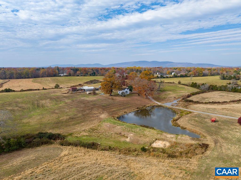 Spectacular investment opportunity with the announcement of future Amazon data center campus in Louisa County's technology overlay district. Amazon web services will create hundreds of jobs for area.  Located within a mile of Gordonsville, this property offers 72.71 acres of which 60 acres are tillable, 3 ponds, and a 2-story farmhouse with 3 bedrooms and 1.5 baths. Location would be perfect for event venue, vineyard, brewery, horse farm or subdivision.  Several massive mature oak trees are located on the property. Outbuildings include an old tobacco barn and grain bins that will hold up to 6,000 bushels. Predominately open rolling land currently used for crops. Views of Cameron Mountain can be enjoyed from the rear field.  Property has Three-Phase power in place.