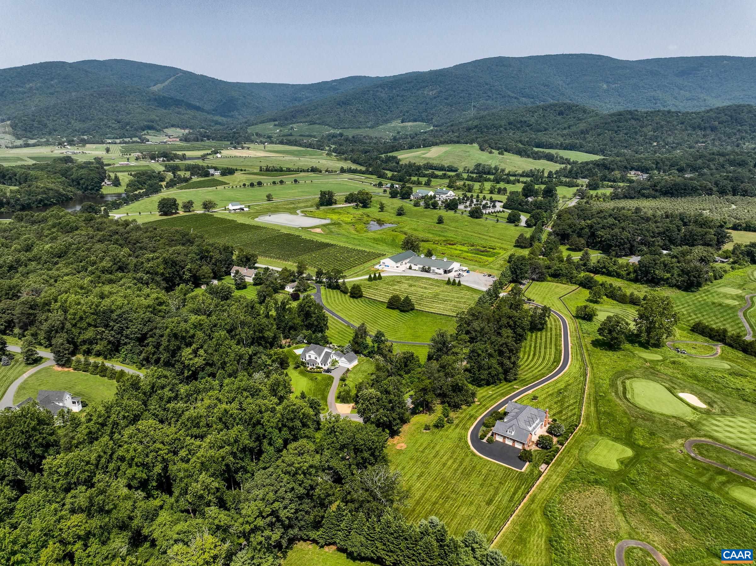 5+ acres overlooking Old Trail Golf Course tees 8 and 18 with incredible mountain views! Cross the street for wine and polo at King Family or enjoy the solitude in your own incredible retreat! This custom built home features 5 large bedrooms and space to expand even more! Gorgeous sustainable hardwood floors throughout the main level welcome you to this light-filled home. The formal living and dining rooms provide luxurious spots for entertaining, but the true heart of the home is the stunning great room with exposed wood vaulted ceiling and stone fireplace and incredible views of the golf course and blue ridge mountains. Gourmet chefs will love the kitchen with cherry cabinets, Silestone counters and bamboo breakfast bar. High end stainless steel appliances sparkle, and the butler's pantry hides small appliances and provides a spot for a wine bar or coffee bar. Escape to the main level primary retreat with two walk-in closets and ensuite bathroom with soaking tub and tile shower.  Upstairs three large bedrooms each feature window seats and large closets.  Two and a half bathrooms give everyone space.  The walk-out lower level features a large rec room and fifth bedroom with multiple unfinished spaces to expand. See agent notes!