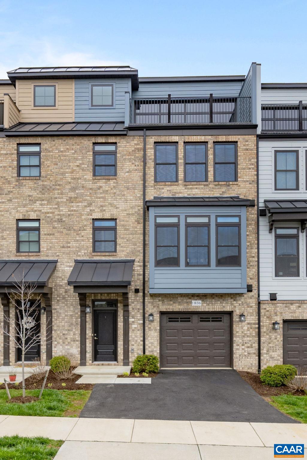 UPDATED PRICE on this like-new beautiful Brownstone-style townhome in Cascadia! The Hartfield model from high quality local builder Southern Development Homes features a fantastic 4th-level rooftop deck with western exposure and panoramic mountain views overlooking Darden Towe Park. An open floorplan features large kitchen, dining area and living room with gas fireplace. Sliding double glass doors lead to rear brick-surrounded private patio, while windows on east side allow for sunrises and west side for panoramic mountain views and sunsets. On the third level there are TWO luxurious primary suites with full ensuite baths, as well as laundry room conveniently located off hallway. Continuing up to fourth level, discover a private roof-top entertainment area with both outside and inside areas for gathering, complete with wet bar, mini fridge, and lower and upper kitchen cabinetry areas. The first level at main entrance completes the home with a third large bedroom and full bath, garage and utility room. Beyond just the breathtaking views, enjoy Cascadia's many amenities, from large pool and clubhouse to picnic pavilion and playgrounds. Fiber optic internet available!