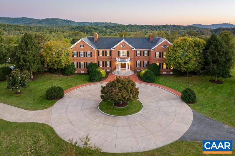 Bentivar Manor - Nestled on over 88 acres of pristine and very private land very close to Charlottesville! This magnificent brick manor home stands as a testament to luxury and refinement. Boasting over 11,600 square feet of finished living space, this estate offers an unparalleled blend of elegance and tranquility. The manor home exudes charm, and showcases superior craftsmanship and attention to detail throughout. Perched upon a gently rolling and elevated knoll, the residence commands panoramic vistas of picturesque fields, mountains, and forests, creating an idyllic retreat just six miles from the heart of Charlottesville. Designed for both relaxation and recreation, the property features extensive trails and boasts long frontage along the Rivanna River. The estate offers an array of amenities, including pastures ideal for keeping animals, a spacious fenced yard complete with a sparkling swimming pool and an impressive professional pickleball court. Several expansive terraces and porches provide additional spaces for entertaining. This captivating estate offers the epitome of luxury living, and a terrific venue for entertaining both small and large groups. PRICED SUBSTANTIALLY BELOW TAX ASSESSMENT!!!