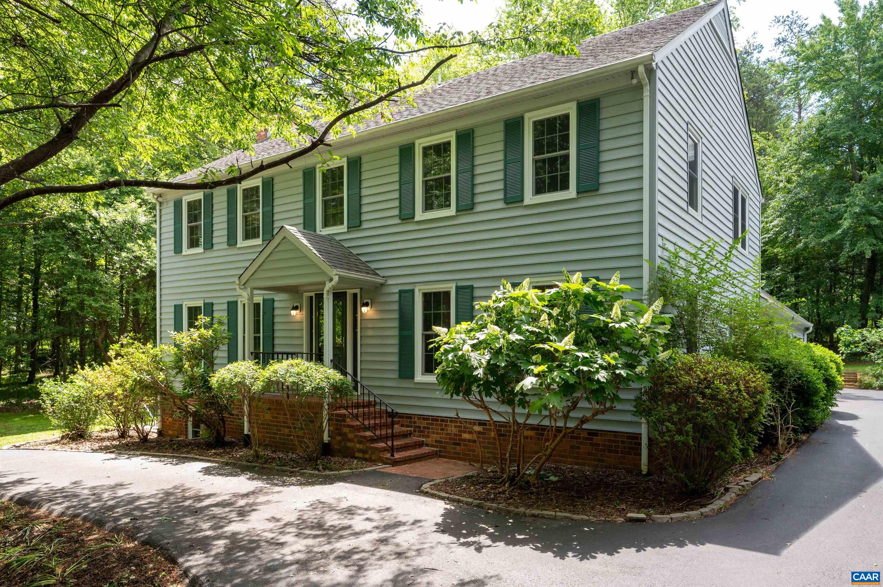 WEST WOODS, the Heart of Ivy. Two story 4 bedroom 2.5 bath house on over 2 acres at the end of a quiet cul de sac. The  close-in, convenient location offers multiple easy & fast access routes to  town , UVA and 29 North. Just around the corner from Ivy Elementary, the property borders 2 adjacent subdivisions: Holkam and West Leigh. The home offers a spacious eat in kitchen with granite counters and cherry cabinets, family room with fireplace opening onto a sunporch and a large, private deck, living room with a second fireplace, formal dining room, small home office, 4 bedrooms & 2 full baths up , attic storage, a oversized 2 car garage, and a large walk out basement. New vinyl windows throughout. Sitting at the top of circular drive in a yard with mature plantings, this property awaits its new owners.
