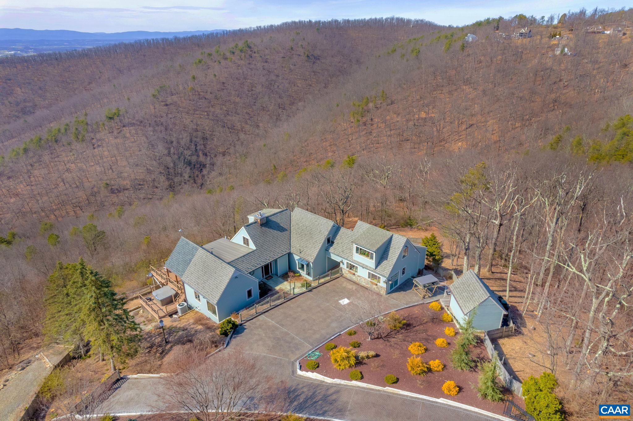 BREATHTAKING VIEWS in Afton on 5.56 acres! Perched on a private hilltop, panoramic mountain views surround this one-of-a-kind custom-built home! This home offers tons of natural light and the inside living and entertainment space extends out to the covered porch and decks for more space to relax or entertain. Designed with quality and low maintenance, easy living with two bedrooms on the main level, along with a separate, second level primary suite and a bedroom or office in the basement. Special features include Hardiplank siding, sunroom with radiant floor electric heating, kitchen with 6-burner gas Dacor cooktop, Subzero refrigerator, &Jaeger & Ernst cherry cabinets, hot tub and hot tub deck, storage room under the sunroom, workshop, artist studio or office, four zone dual fuel heating HVAC for main house, generator, tool shed, updated appliances, 13-zone irrigation system, updated baths and much more. Centrally located to commute to Charlottesville, Staunton or Harrisonburg area amenities. *Also available with a total of 8 acres for 1.05M, MLS #652307 and 13.28 acres for 1.15M, MLS 652316