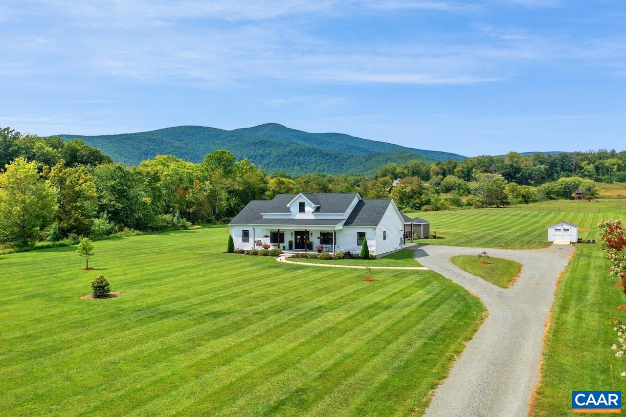 Coveted Afton location with amazing mountain views and a nearly new home built in 2021! One level living with many custom finishes on 7+ acres (mostly level) with your own outdoor oasis; relax and entertain on the covered front porch or the private back patio with outdoor kitchen, pool, and hottub with the best of views! Perfect set up to love where you live everyday or as that special getaway. Tremendous potential as an income generating short term rental - centrally positioned in a thriving area along the Nelson 151 wine and brew trail AND minutes to endless outdoor recreation opportunities like golf, hiking, and skiing; less than 30 min to Charlottesville. Zoned agricultural with plenty of space for play, pets, gardening and a few animals (chicken coop can convey) and within a community of high-end homes with NO home owners association or restrictions. Extras: open flow, hardwood floors, gas fireplace, gourmet kitchen (quartz countertops, island, and huge walk-in pantry), split bedroom design to allow maximum privacy for primary suite with walk-in closet and spacious bathroom (soaking tub, shower, double vanity), attached carport, conditioned crawl, fiberoptic internet, well yielding 30 gpm, greenhouse, workshop, and more!
