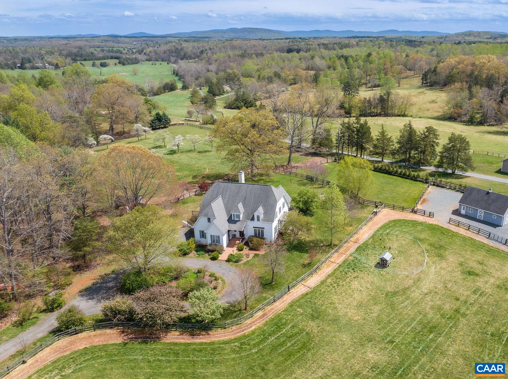 Nestled in the heart of Farmington Hunt country, this well-maintained horse farm spans 15 acres, w/ 3-stall barn expandable to 5 stalls, paddocks, special care dry lot track, automatic waterer, and five-acre flat hay field/schooling area. Located just minutes from fox hunting fixtures, the farm provides easy access to a vibrant equestrian community and the area’s rich traditions. Set amidst perennial gardens and mature trees, the 4-bedroom, 3.5-bathroom house envelops you in a warm ambiance, where every corner feels inviting, and every window frames a storybook view. The soaring ceilings in the great room uplift the spirit and open living spaces allow for a gentle flow from the foyer to the great room, kitchen, and sun room. The kitchen is both stylish and functional, featuring custom no-VOC maple cabinetry and large island. Just off the kitchen, the sun room has direct access to the patio surrounded by perennial gardens and the peaceful sight of horses grazing nearby. The formal dining room opens to a deck and connects to the LR through pocket doors. This is an exceptional offering in Albemarle County. Don't miss the informative brochure in the media link.