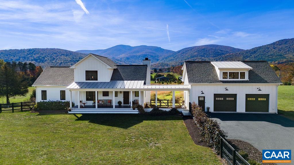 Coveted Afton location, just 2 miles from the Albemarle border and 25 minutes from UVA, this stunning property boasts high-level finishes and breathtaking mountain views. Savor the beauty of sunsets over Humpback Rock from the expansive deck, or take in the tranquility of a 2-acre private wildlife meadow. The spacious front porch, with a ceiling fan and porch swing, overlooks a fenced 1/2-acre yard—perfect for pets and play. The primary suite boasts a luxurious bath with a marble rain shower, dual vanities, walk-in closet, and a connected laundry room. White oak floors and bluestone tile are showcased throughout, combining timeless style with durability. The custom kitchen features Brazilian soapstone counters, open shelving, and a butcher block island. The living room is made for cozy evenings with its reclaimed white oak beam mantle and wood-burning fireplace. Above the garage, a 650 sq. ft. space with its own entrance, HVAC, and rough-ins for a bath and kitchen offers endless possibilities. With wineries and breweries just around the corner, this home offers the perfect blend of serenity and excitement.