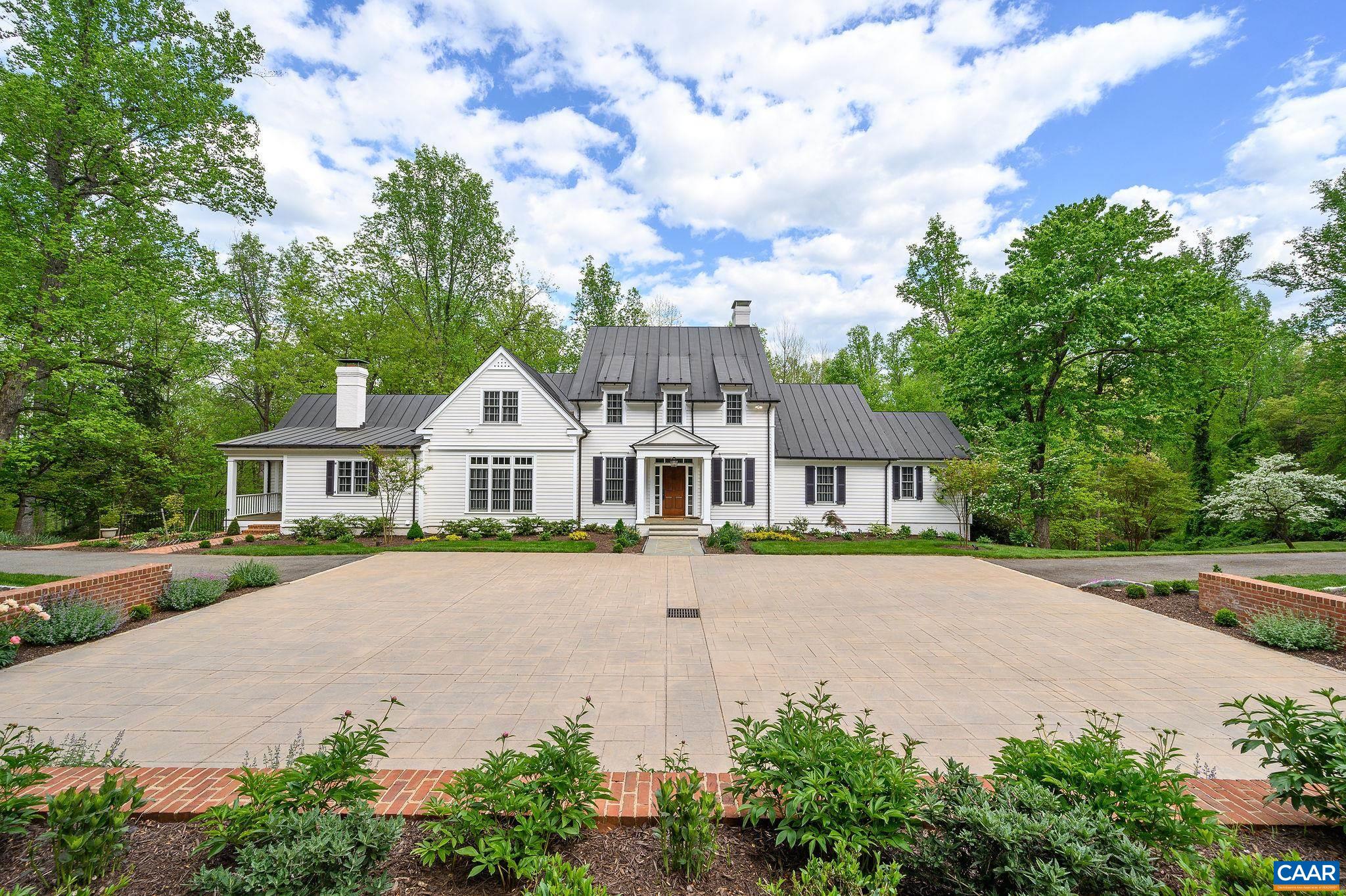 Timeless elegance and modern luxury set apart this one-of-a-kind residence in historic Farmington. The turnkey home is generous in scale and sophistication. Its meticulous renovation and expansion provide every comfort suitable to contemporary living. The primary suite is located on the first floor. The kitchen, with high-end appliances, custom cabinetry, and walk-in pantry, opens into the family and formal dining rooms, both of which access a stunning screened porch and allow for effortless entertaining, inside and out. There are six bedrooms in total, including three on the second floor. The terrace level, complete with two more bedrooms and a kitchenette, includes multiple versatile rooms, perfect for a theater, office, or home gym. The property maintains its privacy thanks to thoughtful siting, grading, and landscaping. The grounds include gardens, boxwoods, centuries-old trees, useful hardscaping, and several acres of untouched forest. Highlights include an elevator, three fireplaces, two laundry rooms, an oversized garage, copper roof and gutters, and a whole-house generator. The attention to detail and uncompromising standards of this exquisite property have turned a classic house into an unforgettable home.