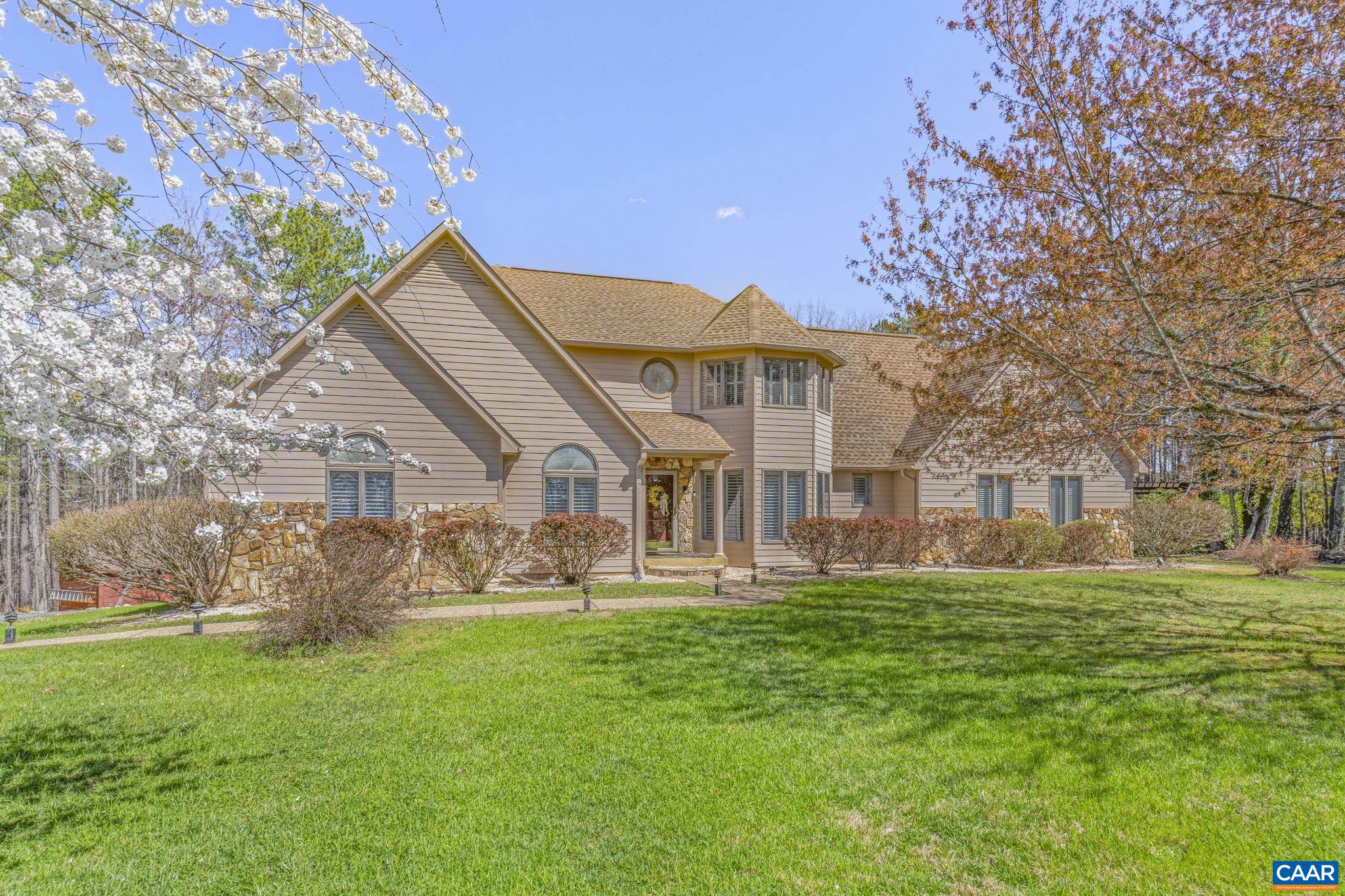 Price Adjustment. Welcome to Ridge View in Albemarle County. This beautiful home offers a stunning yard where something is always in bloom! From vibrant roses to flourishing fruit trees, you'll enjoy a variety of plants blooming throughout the seasons. A true paradise for garden lovers. This custom-built home offers breathtaking mountain views and a beautifully landscaped yard, blending charm with modern upgrades. From the moment you arrive, the stone pillars at the entrance set the tone for elegance and warmth. Step inside to find vaulted ceilings, upgraded molding, custom built fireplace, and stunning trim work that enhance the home’s inviting atmosphere. The main level features a den, formal dining room, spacious kitchen, great room, primary suite, sunroom, laundry room, and a half bath—all designed for comfort and functionality. Upstairs, you’ll discover two additional bedrooms, a full bath, attic space, and a versatile bonus room over the garage. The home includes a two-car garage, plus an additional one-car garage with unfinished loft space for future possibilities. The outdoor spaces are a true retreat, featuring multiple gardens, patios, and a large pergola—perfect for entertaining.