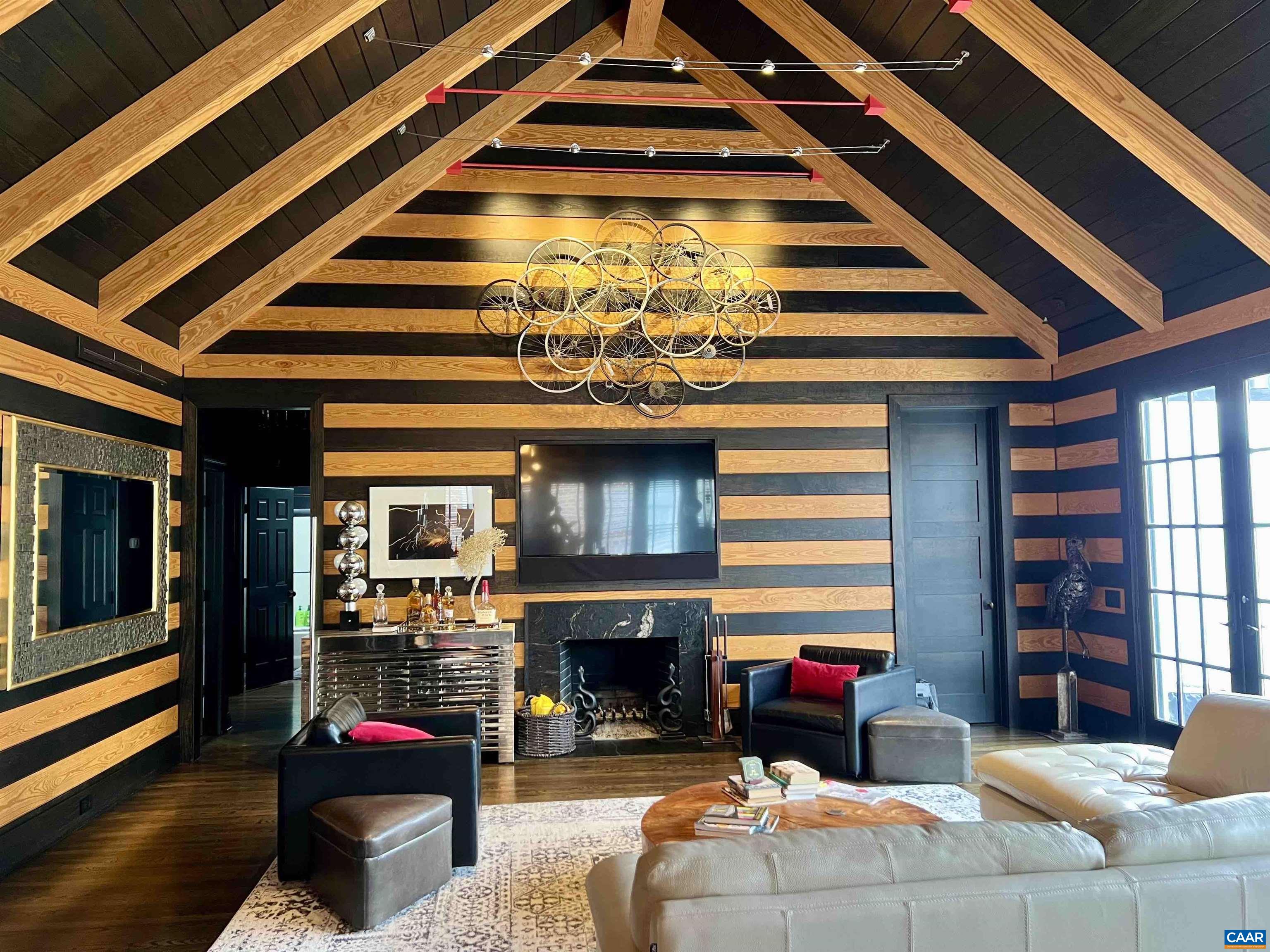 DISCOVER A BREATHTAKING, EYE-OPENING RETREAT IN THE HEART OF GLENMORE, WHERE MODERN SOPHISTICATION MEETS TIMELESS CRAFTSMANSHIP.  THIS ONE-LEVEL MASTERPIECE BOASTS AN UNPARALLELED DESIGN BY MICHAEL & CANDICE DELOACH, FEATURING A GREAT ROOM WITH CUSTOM BLACK AND NATURAL WOOD PANELING, VAULTED CEILINGS WITH EXPOSED WOOD BEAMS.  THIS ROOM IS ANCHORED BY A CUSTOM BRONZE F/P CRAFTED BY BROWNELL METAL STUDIO.  THE GOURMET KITCHEN IS EQUIPPED WITH A 48" WOLF RANGE & HOOD, OLD GROWTH HEART PINE CABINETS SOURCED FROM A 1900 ERA WAREHOUSE AND EXTRA THICK BRAZILIAN GRANITE COUNTERTOPS AND A 200 BOTTLE EURO-CAVE WINE CELLAR/CABINET.  THE PRIMARY BATHROOM FEATURES A JULIAN CHICHESTER ORIGINAL CABINET RETROFITTED WITH A GRANITE TOP.  STEP OUTSIDE ONTO THE IPEA  WOOD DECK WITH OUTDOOR KITCHEN AND BUILT-IN GRILL, IDEAL FOR  AND SOCIAL GATHERINGS.  PROPANE-FED TANKLESS HW HEATER.   THIS HOME IS NOT JUST A RESIDENCE, IT IS A STATEMENT OF ARTISTRY AND LUXURY.   ONE OF A KIND!