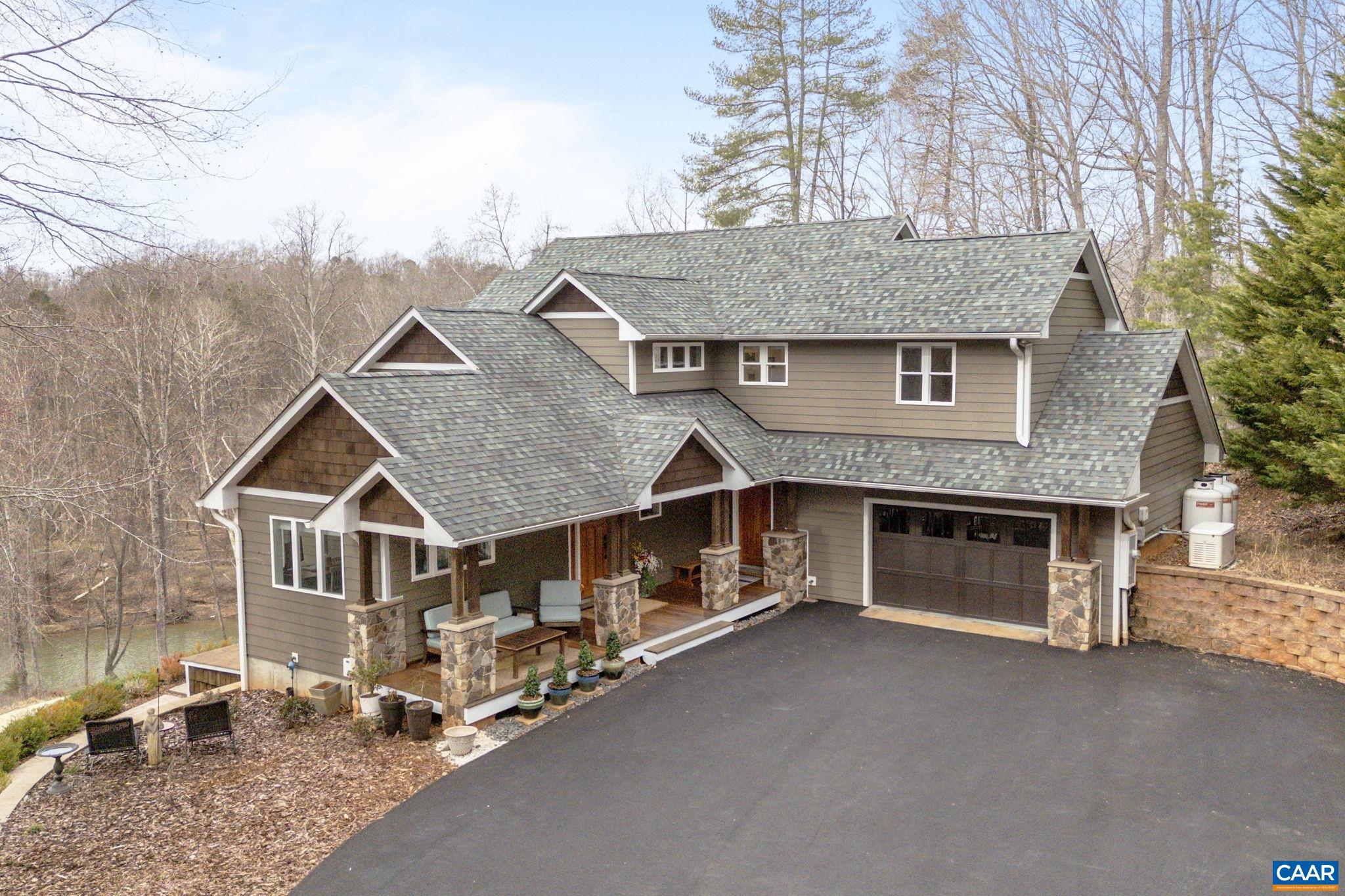 Escape to your private waterfront oasis in this stunning waterfront property. With breathtaking views of the river, 6.2 acres, a private beach and plenty of outdoor space, you'll feel like you're on vacation every day.  This gorgeous home features abundant windows to enjoy the views and for abundant natural light. Chef's island kitchen with beautiful cabinets and granite countertops.  Gaze outside from your comfortable vaulted great room with fireplace. Enjoy nature while working from your home office.  Wake up to morning coffee on the master suite balcony while enjoying the view.  2 additional large bedrooms and full bath on the upper level.  Walkout terrace level features spacious family room with fireplace and full bath.Beautiful hardwood floors throughout this lovely home. Lots of outdoor enjoyment to be found here with covered front porch, rear deck, plunge pool and large patio area with firepit.  Enjoy this private oasis while living only minutes from UVA, NGIC, schools, shopping and restaurants.
