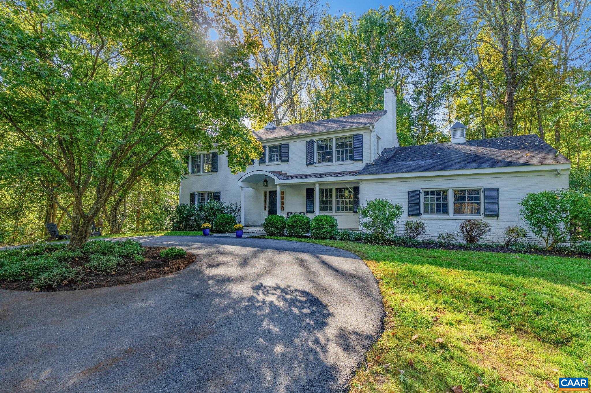 In Flordon, this classic brick residence, painted white, has been renovated to blend lasting charm with modern convenience. There are five bedrooms, including a large primary suite with three walk-in closets, a luxurious ensuite bathroom, and a fireplace. The main level features an updated kitchen with marble countertops and a gas range, a formal dining room, seamless transitions from multiple comfortable living rooms, the functionality of two bathrooms and a mudroom with cubbies, and access to the screened porch, back yard, and garage. The terrace level has a bedroom, full bathroom, enormous rec room, and wet bar. Additional highlights include a gracious foyer, three fireplaces in total, five full bathrooms, numerous built-ins, thoughtful design on all three floors, and considerable storage. The nearly level, 1.57-acre lot has a fenced back yard, large side yard, two driveways, and ample space for property enhancements, if desired. Enjoy proximity to all things Charlottesville, UVA, myriad conveniences, Western schools, private schools, and more. In a terrific location, come see a house that makes everyday living effortless and enjoyable.