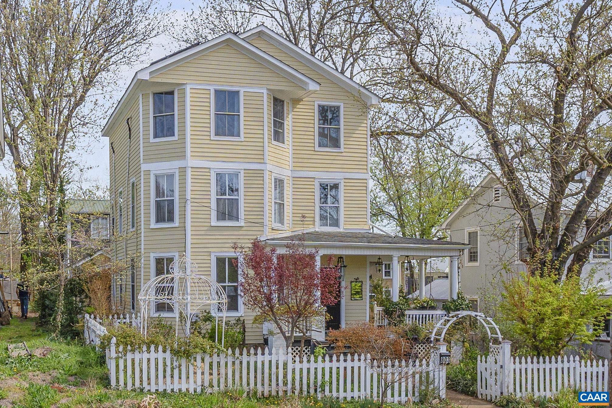 This remarkable and spacious Belmont gem finds the perfect balance of historic Charlottesville charm and modern living and is not to be missed.  Fronted by a classic wraparound porch, the opened and expanded entry level boasts numerous windows, high ceilings & a variety of sitting and mixing spaces which flow easily into the central kitchen. Close at hand is the breakfast nook, cozy under skylights and vaulted ceiling as well as the walk in pantry, sunroom, powder room and rear patio area. The second floor offers a large, many windowed bedroom, full hall bath with laundry and a second ensuite bedroom bath combination. The third floor features two additional bedrooms, each with dedicated modern baths, large walk in closets, additional storage and commanding southwestern views of the city and mountains beyond.  Among the numerous improvements and updates are solar panels mini-splits & heat pump, modern windows, plumbing, electrical & lighting, 6 year old roof and freshly painted siding while exposed beams, high ceilings and original doors & moldings harken to times past.