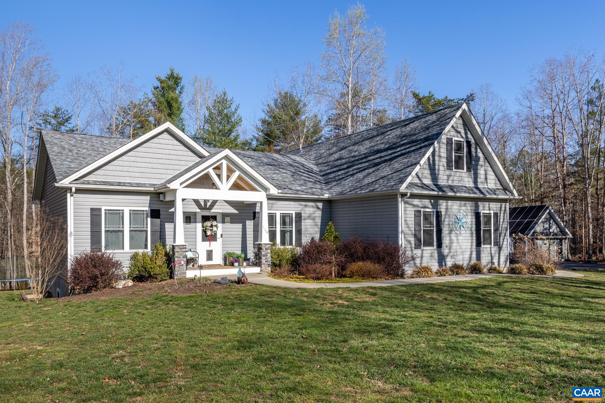 The peace & quiet of country living nestled on 6.6 acres with tons of privacy!  This 4,000 sq. ft., 5 bedroom/4 bath home was designed for larger family livability that offers comfort and style.  Enter into main level that has an open concept floor plan to include a chef's kitchen with gas range, double wall oven, quartz counters, pantry, & island.  A dining area, family room with fireplace, first floor master suite w/walk-in closets, master bath w/double vanity, two additional bedrooms and full bath, mud room w/washer/dryer hookup. Walk out onto the closed-in porch or on the deck where you can entertain family & friends all year long either relaxing in the hot tub or taking a swim in the pool while the kids can enjoy hanging out in the tree house or everyone can meet at the fire pit to roast S'mores. The upper level has a separate study & office space, which could be used as addtl. bedrooms and a full bath. Lower level offers separate living with kitchen, dining area, family room, 2 bedrooms, rec/exercise room, laundry & full bath with walkout access to the hot tub or pool.  Hardwood floors throughout. Home has internal/external home sound system.  Chicken coup & shed convey.  Energy efficient solar installed.  No HOA!