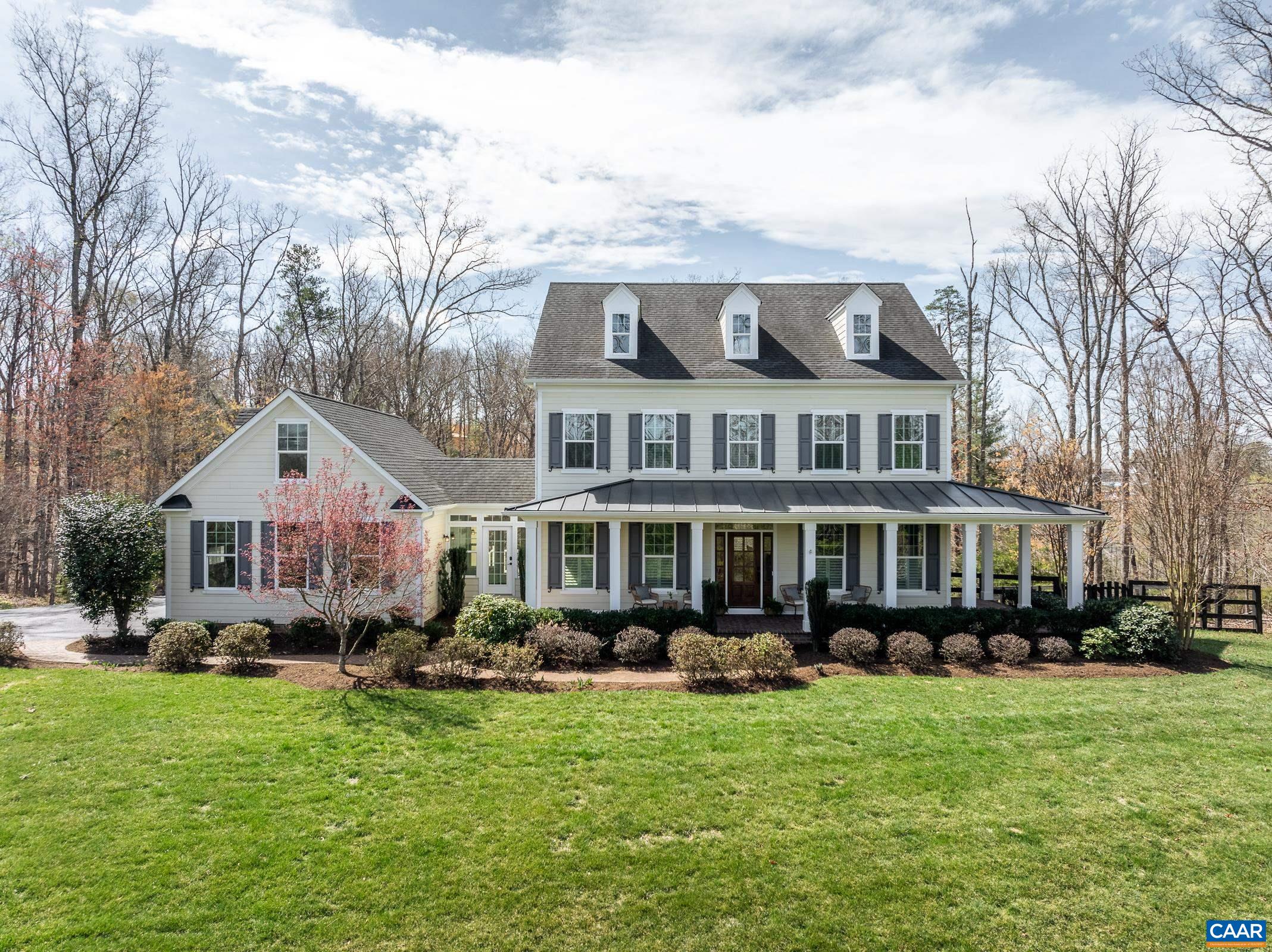 Situated on an elevated Glenmore estate homesite of well over an acre, this lovingly cared-for classic Virginia farmhouse will not disappoint! Thoughtfully designed open concept floor plan, sun drenched rooms, exceptional millwork throughout, expansive wrapped front porch, and featuring a rare combination of comfort and elegance! The heart of this beautiful home is the finely appointed chef's kitchen with enormous island, extensive custom painted cabinetry, high end stainless appliances, apron front farm sink, and plenty of prep and cooking space for even the most discerning chef. Chic butler pantry leads you to the elegant dining room. A comfortable great room, large breakfast area, study, mudroom, and half bath complete the main level. The freshly painted primary suite offers two oversized walk in closets, a beautifully detailed primary bath, and secluded sitting area with its own private deck. All the bedrooms are ample in size, boast great closet space, and there's even a spacious loft area. Finished basement simply must be seen! Beautifully detailed bar which opens to rec room and family room with gas fireplace. Enjoy movie night in the amazing home theater! All of this offered on one of the finest homesites in Glenmore!