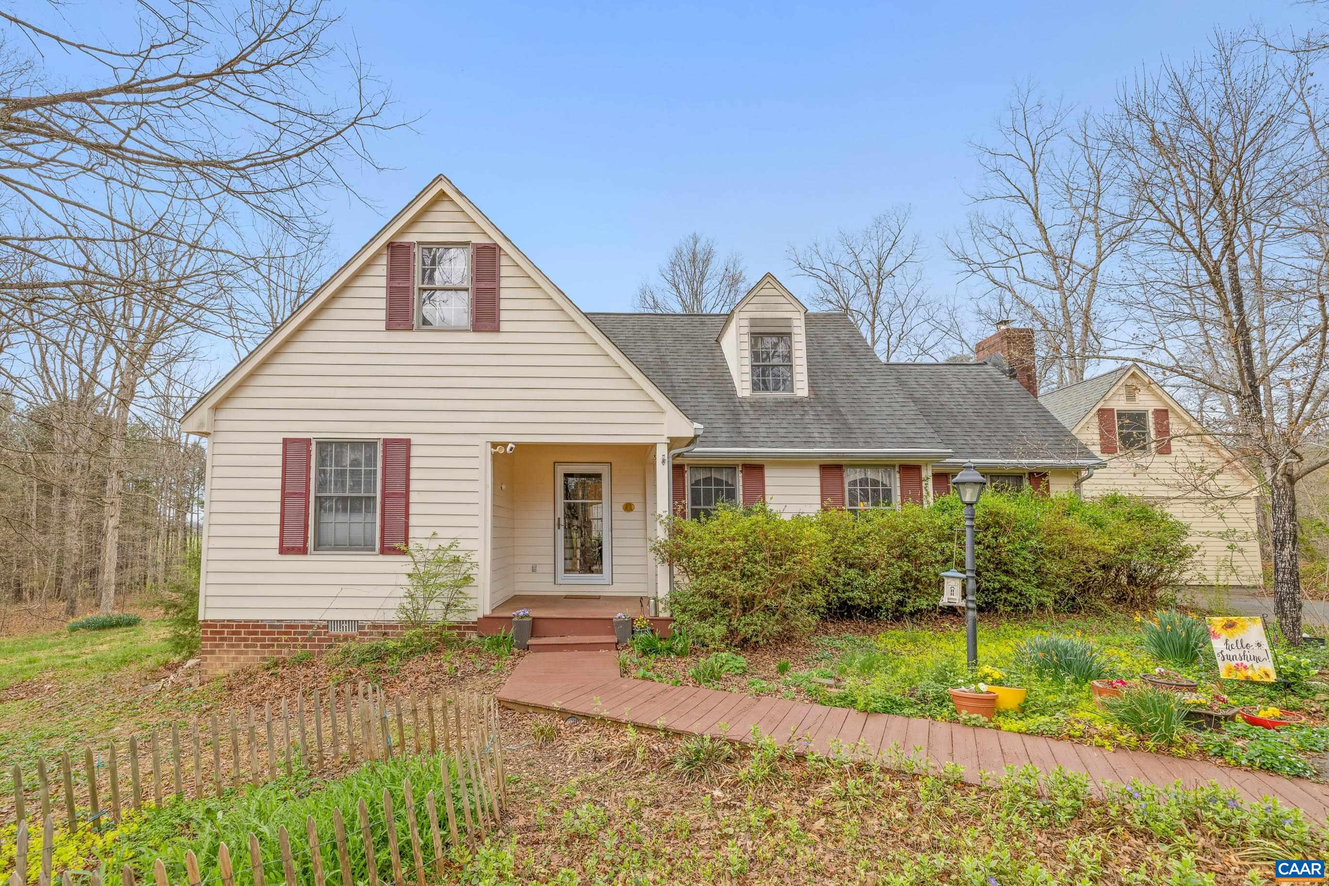 Looking for that perfect blend of privacy, charm, and convenience? This beautiful property is just 10 minutes to downtown, major hospitals, and UVA, only 20 minutes to the airport, and just 5 minutes from historic Monticello and Michie Tavern. Set on a private lot with multiple outdoor living spaces—including a welcoming front porch, a patio with fire pit, a spacious deck ideal for entertaining, and a relaxing hot tub—this home offers a peaceful retreat with easy access to everything. Inside, you'll find hardwood floors throughout, a cozy family room with a wood stove and French doors that open onto the deck, framed by a blossoming dogwood tree. The spacious primary bedroom is conveniently located on the main level and features an en suite bathroom and generous closet space. Upstairs, two additional bedrooms share a full bath, and there’s abundant storage in the attic. You’ll also love the extra detached space—perfect for a home gym, office, craft studio, or more room to store your things. Enjoy nearby walking trails and the serenity of nature with all the comforts of home. This is the country life you’ve been waiting for—without sacrificing city convenience!