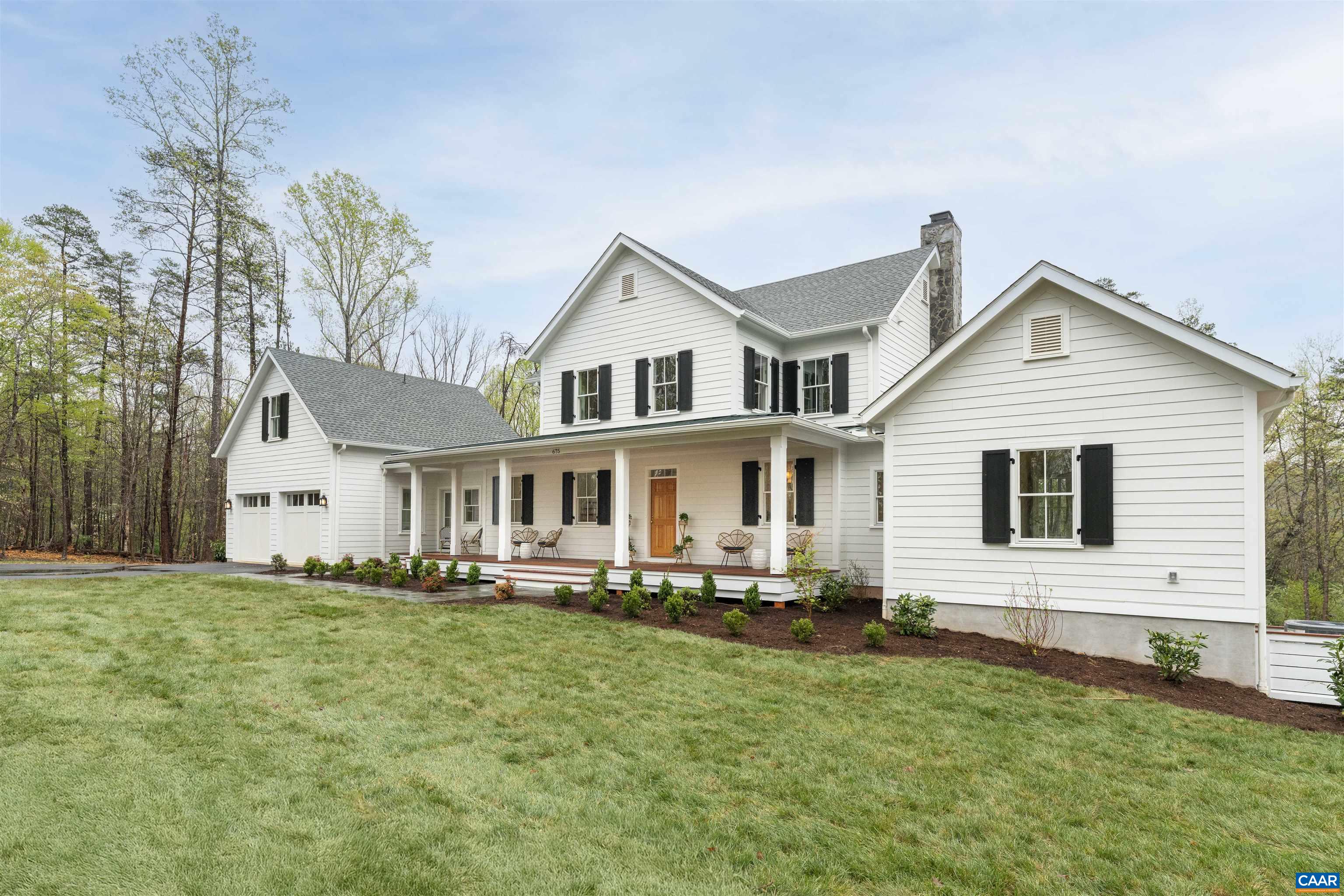 Rare new, custom construction in Ivy! This classic farmhouse was designed by local architect Bahlmann Abbott and features a beautifully designed floorplan with a focus on modern living. Walk up the bluestone walkway to the long, classic covered front porch and open the Douglas Fir front door to enter an oversized foyer that welcomes you to an open layout main level. The chefs kitchen features gorgeous inset cabinets with Aegean marble counters, a 36 inch Kitchen Aid Gas Range with custom cabinet style hood, and built in Kitchen Aid french door refrigerator. The island offers a great space for entertaining while overlooking the dining space and living room with 42" wood burning fireplace. Down the hall find a first floor primary bedroom oasis with a spa like bathroom with frameless glass shower, deep soaking tub and oversized double vanity. The main floor also includes off the kitchen: a bar, an oversized laundry room, and a gracious mudroom with custom built ins and stairs that lead to a finished room over the garage with full bath - ideal for a home office or private guest space. Upstairs offers gorgeous hardwood floors, 3 comfortably sized bedrooms, 2 bathrooms (one ensuite), and a loft perfect for crafts or a play area.