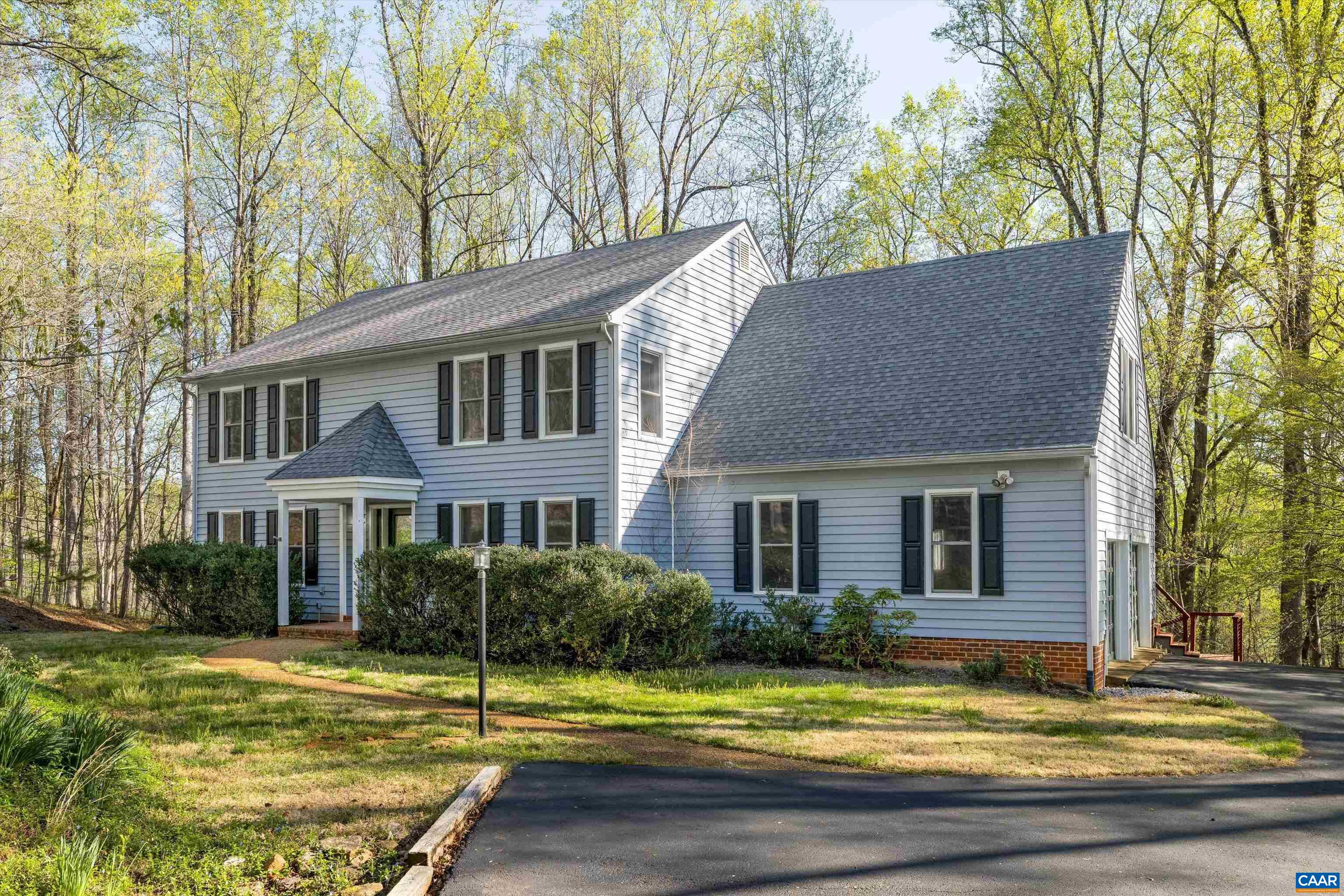 PRIVATE IVY RETREAT IN HIGHLY SOUGHT-AFTER WESTERN ALBEMARLE! This stunning 5 bedroom, 3.5 bath home offers nearly 4,000 square feet of living space on a beautifully landscaped 3.17 acre lot. Enjoy quick access to Ivy Elementary, Blue Ridge Swim Club, and Duner's while being only 15 minutes to UVA and Downtown Charlottesville. The spacious eat-in kitchen features stainless steel appliances, custom cabinetry, granite countertops, and a butler’s pantry, with easy access from the kitchen to an expansive deck overlooking the private yard. Enjoy cozy evenings by one of the two brick fireplaces in the living room or basement. The primary suite boasts skylights and a bathroom with dual vanities. A dedicated home office provides the perfect space for remote work or study. Additional highlights include a large laundry room, a full finished walk-out basement, and a patio. Recent improvements include new LVP flooring on main level, new carpet upstairs, and interior paint throughout the home. This private retreat offers the perfect balance of space, comfort, and tranquility. Schedule your showing today!
