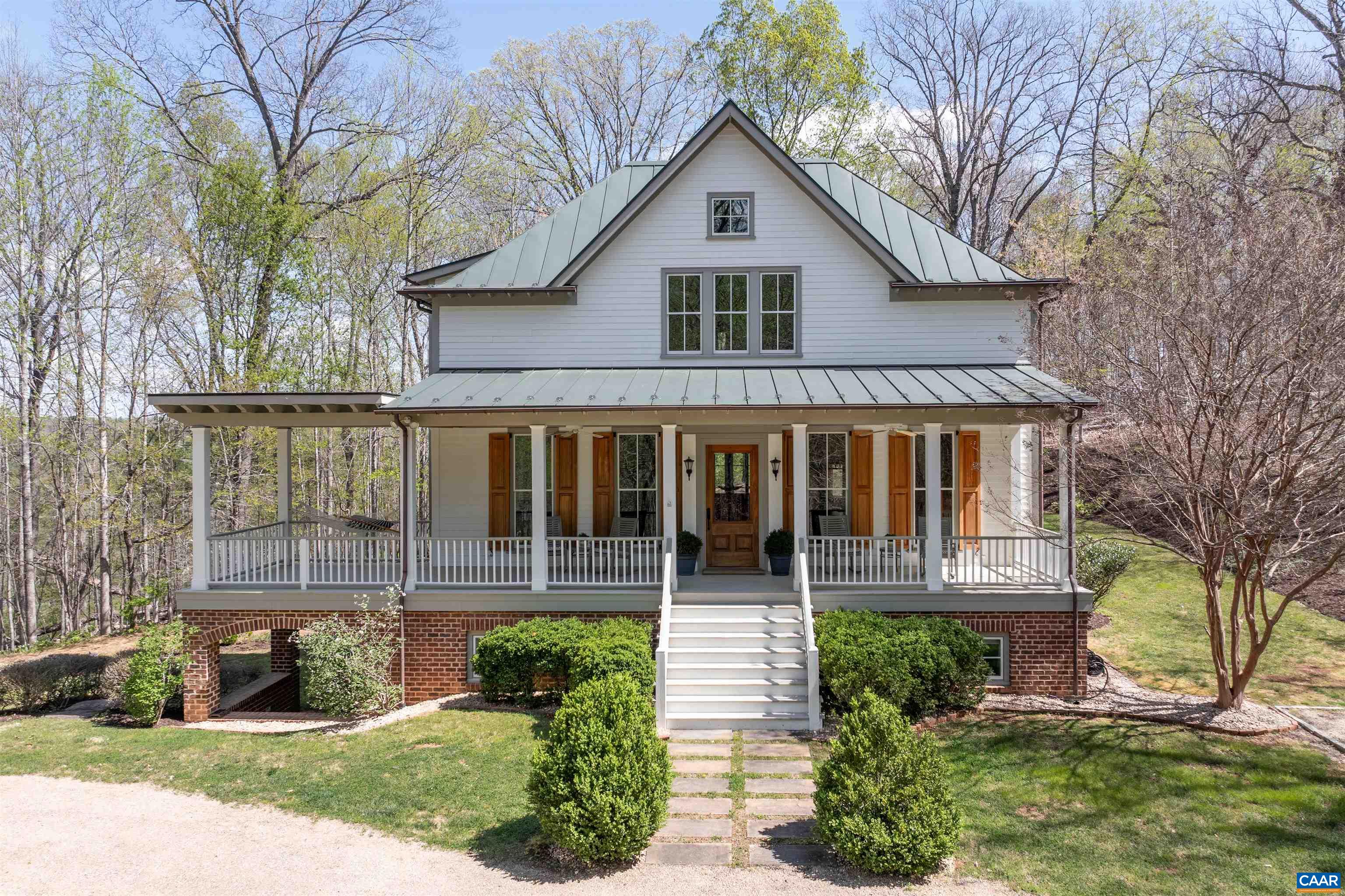 Sited on over 23 exceptionally private acres and featuring bold mountain views, this Peter Johnson built, quintessential Virginia farmhouse perfectly captures today's taste for bright, open living spaces warmed by striking accents that create a sophisticated, yet cozy feel.  Step inside and prepare to be wowed by beautiful hardwood floors milled from trees from the property, stunning ceiling beams recovered from a Pennsylvania bank barn, & a handsome reclaimed wood and soapstone island that is the centerpiece of the kitchen.  Floor to ceiling windows flood the home with natural light, while a dramatic stone Rumford fireplace in the great room offers a focal point for family gatherings.  Other outstanding features include energy effiicient geothermal heating & cooling, radiant flooring on 2 levels, and 10 foot ceilings throughout.  This idyllic setting is highlighted by brick and stone walls and patios, and multiple outdoor spaces for enjoying the solitude, including a welcoming front porch and a huge rear screen porch off the kitchen.  Built to exacting standards and meticulously maintained, and just 20 min. to Charlottesville airport, 15 min. to Downtown Cville, Martha Jefferson & UVA Hospitals, and UVA Grounds.