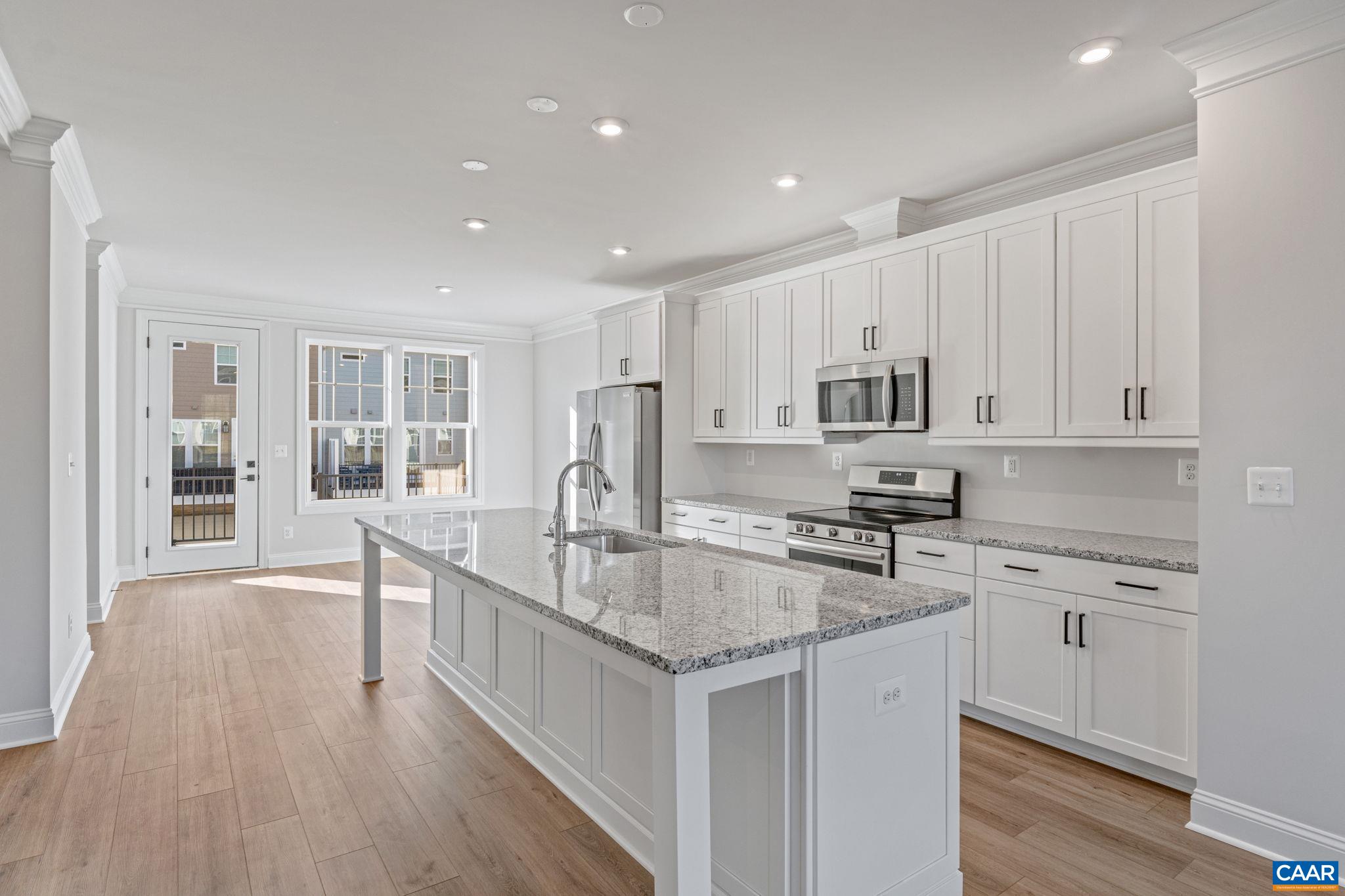 Just Completed – Actual Photos! Welcome to The Dogwood in Glenbrook, a farmhouse-style townhome surrounded by Blue Ridge Mountain views, parks, and trails—just minutes from Downtown Crozet. This thoughtfully designed home offers three finished levels, including a flexible basement rec room and rear-entry 2-car garage. The open main floor features a bright kitchen with a large island, white cabinets, walk-in pantry, and stainless steel appliances. Upstairs, enjoy a spacious primary suite, two additional bedrooms, full hall bath, and laundry. High-end finishes throughout include oak stairs, solid core doors, wood shelving and upgraded trim. Glenbrook includes a tot lot on the block, a path to Crozet Park, and direct access to Downtown.
