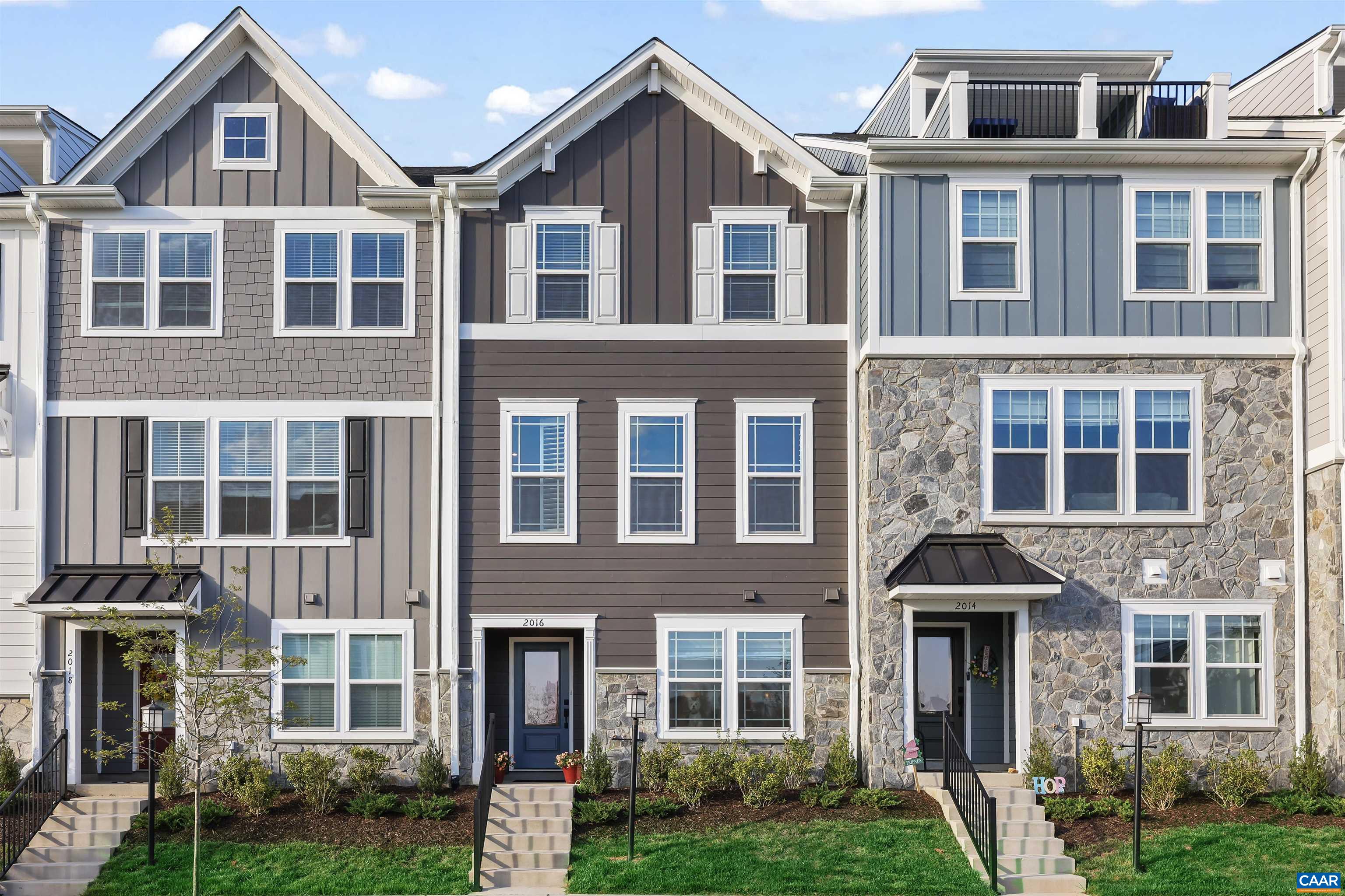 Welcome to this gorgeous townhome built in 2023, offering modern appeal and a like-new feel throughout. From the moment you enter, you're greeted by a cozy sitting room just off the foyer and sleek LVP flooring that flows through the main level. The open, inviting layout features recessed lighting and thoughtfully chosen finishes including plantation shutters, Roman shades, and 2-inch faux wood blinds. The bright eat-in kitchen is a standout with white cabinetry, granite countertops, a large island with seating, stainless steel appliances, and stylish pendant lighting. A cheerful breakfast nook overlooks the deck, and the adjacent living room provides the perfect spot to unwind. Upstairs, plush carpeting leads to generously sized bedrooms, including a primary suite with its own private bath. Outside, enjoy the nicely sized deck and beautifully landscaped surroundings. The attached two-car garage includes an EV charging port, plus extra driveway parking in the rear. Set in a fresh new community framed by stunning Blue Ridge Mountain views, with parks and walking trails just steps away—this home is the perfect blend of style, comfort, and location.