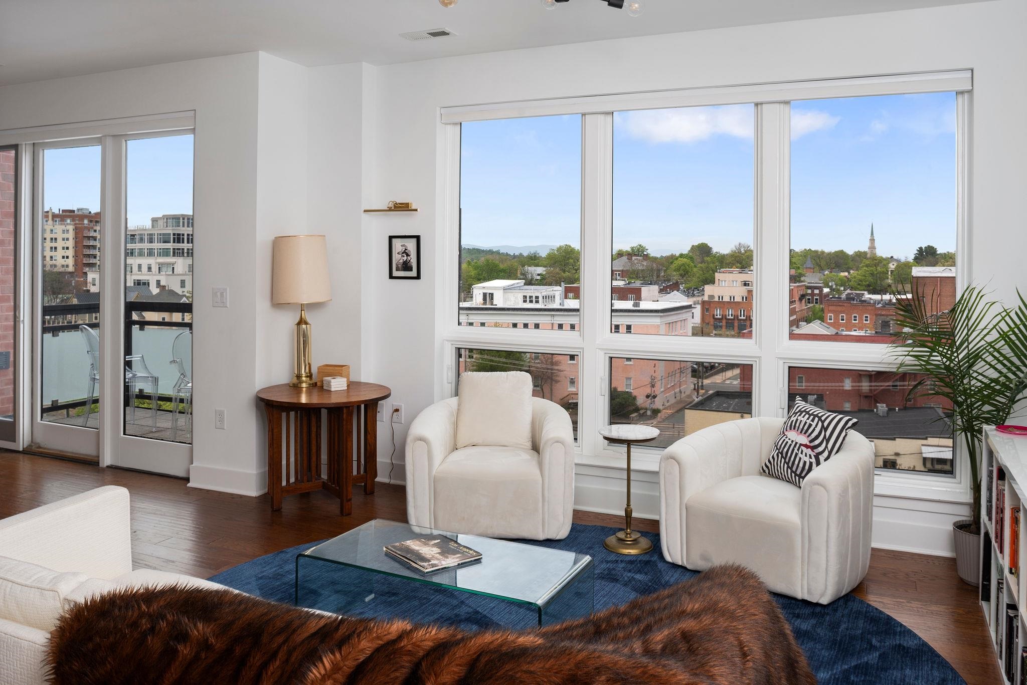 Exceptional Opportunity to Live on the TOP-FLOOR PENTHOUSE with Stunning Views! Discover this hidden gem at THE GLEASON—an impeccably maintained, quiet building in the heart of downtown Charlottesville. This light-filled, luxury penthouse condo offers panoramic views from downtown to the Blue Ridge Mountains, with timeless hardwood floors, electronic blinds and smart storage throughout. Enjoy unbeatable walkability to top restaurants, live music, Violet Crown theater, and the Saturday farmers market right outside your door. ACAC fitness club is next door, and Art IX is just behind the building. Perks include a covered, dedicated parking space with EV charging potential, TING fiber, private storage, secured entry and elevator access.  Best of all is the 10x6 balcony offering pristine views of the dynamic downtown cityscape and Blue Ridge Mountains.  Schedule your private showing today—this rare find won’t last long!
