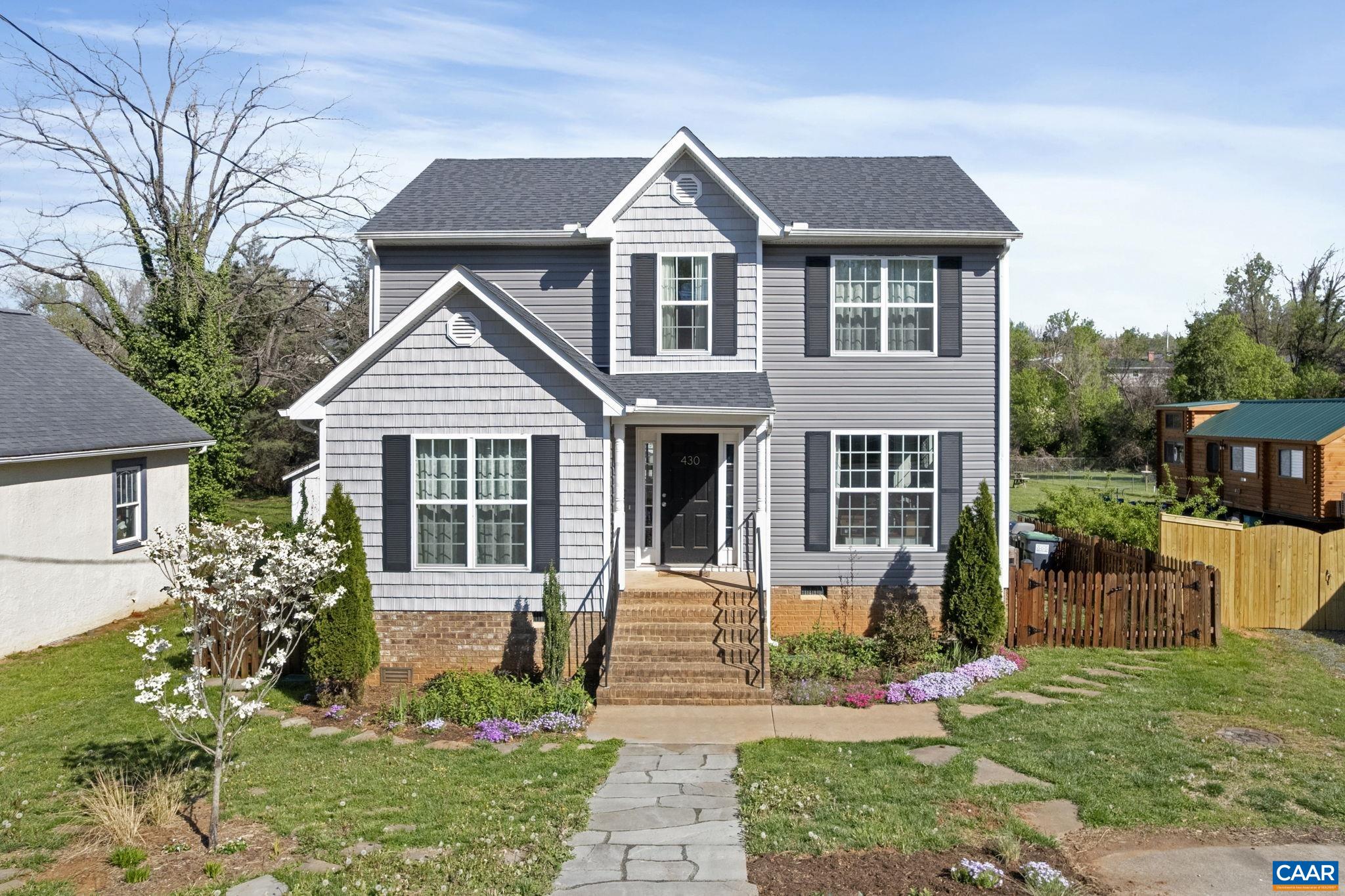 Built in 2019—a true rarity in the City of Charlottesville—this 4-bedroom, 2.5-bath home offers the best of both worlds: modern construction in an established, walkable neighborhood. Located in the vibrant Woolen Mills area, just a 2-minute walk to Meade Park and Onesty Pool, this home combines convenience, function, and style. The layout is refreshingly sensible, featuring a main-level primary suite, light-filled living spaces, and 3 additional bedrooms upstairs. Thoughtful landscaping with native plants adds beauty and ecological value to the front yard, while the flat, fully fenced backyard is ideal for pets, play, or gardening—another rare find in the city. A 5.6kW solar panel system on the roof (fully paid off) provides major energy savings, with nearly $0 electric bills during the summer months and minimal bills in the winter. It’s a smart, sustainable upgrade that adds real long-term value! Set within easy access to Downtown, the Rivanna Trail, and local favorites like the Downtown Mall, markets, and restaurants, this home is a standout opportunity in one of Charlottesville’s most dynamic neighborhoods.