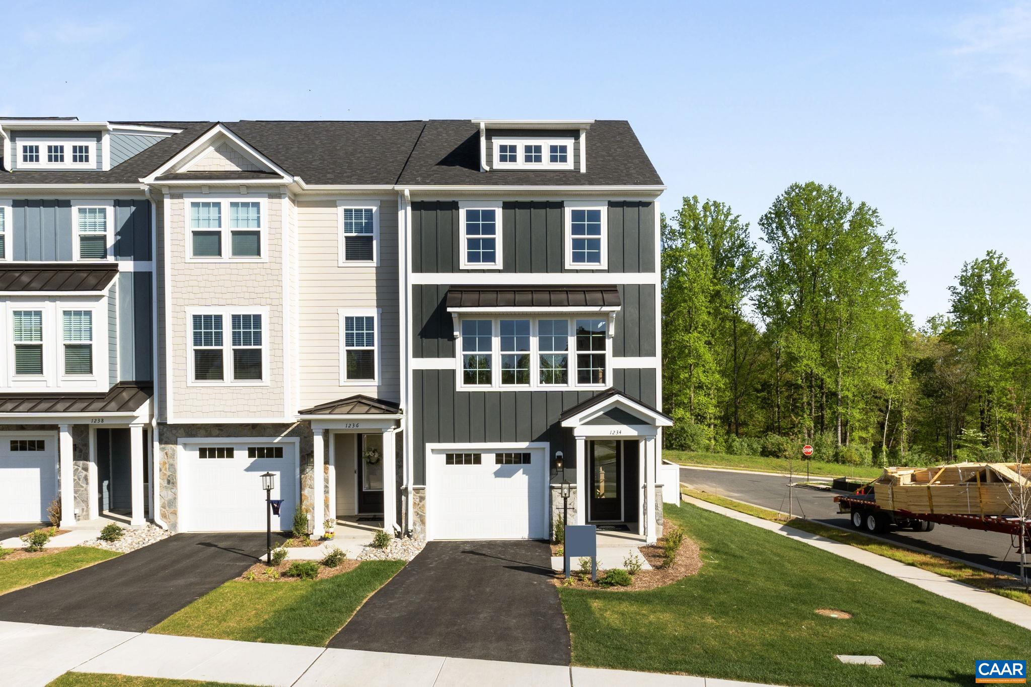 Discover the Holly I, a beautifully designed three-story end unit townhome in the newest section of Belvedere, set for an early Fall '25 completion! This spacious home features a flexible layout, starting with a rec room and half bath on the first floor, perfect for a home office, gym, or additional living space. The second floor’s open-concept design includes a large kitchen with a walk-in pantry, a generous dining area, and a sunlit family room, plus an included screened-in porch for outdoor enjoyment and an additional half bath. Upstairs, the primary suite offers a luxurious en suite bath, while two additional bedrooms share a well-appointed hall bath. The laundry is conveniently located on the third floor, and thoughtful upgrades like oak stairs with open railings add style and functionality. A front-facing one-car garage provides parking and storage.  Belvedere offers an array of amenities, including access to parks, close proximity to the Rivanna trailhead, the nearby SOCA Fieldhouse, a dedicated dog park for pet owners, and enchanting playground areas.  Photos are of similar model home and may show optional upgrades.