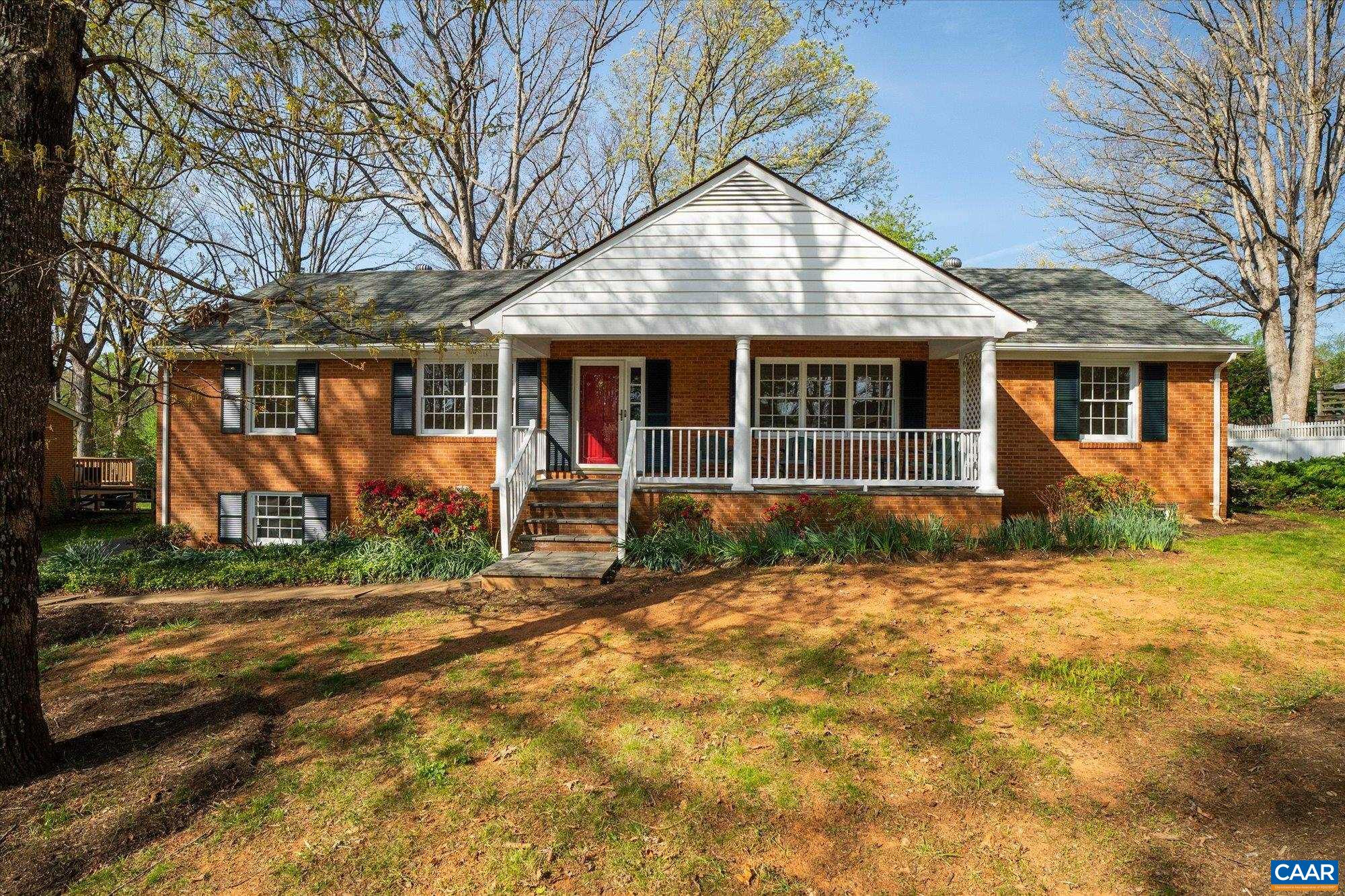 This beautifully updated brick ranch home offers space, flexibility, and comfort—all in a classic Carrsbrook neighborhood location between Route 29 and Downtown Charlottesville. Offering as many as 5 bedrooms and 3 full baths, this home is move-in ready with fresh paint, an updated kitchen, refinished hardwood floors, new carpet, and LVT. The home welcomes you with a lovely, covered porch and open foyer leading to formal living and dining rooms, and an eat-in kitchen. Along the main hall, 2 guest bedrooms share a large bathroom, while the generously sized primary suite includes its own en-suite bath.  Enjoy the benefit of a completely level backyard and seamless outdoor living on the screened-in rear patio. The finished basement offers over 1,000 sq ft of additional living space with a second fireplace and custom bar area. Additional rooms would be ideal for a home office, gym, playroom, or a guest suite—plus ample storage areas. A partial backup generator with automatic transfer switch provides peace of mind and convenience. Filled with natural light and thoughtfully updated, this charming home offers the perfect blend of space, character and location.