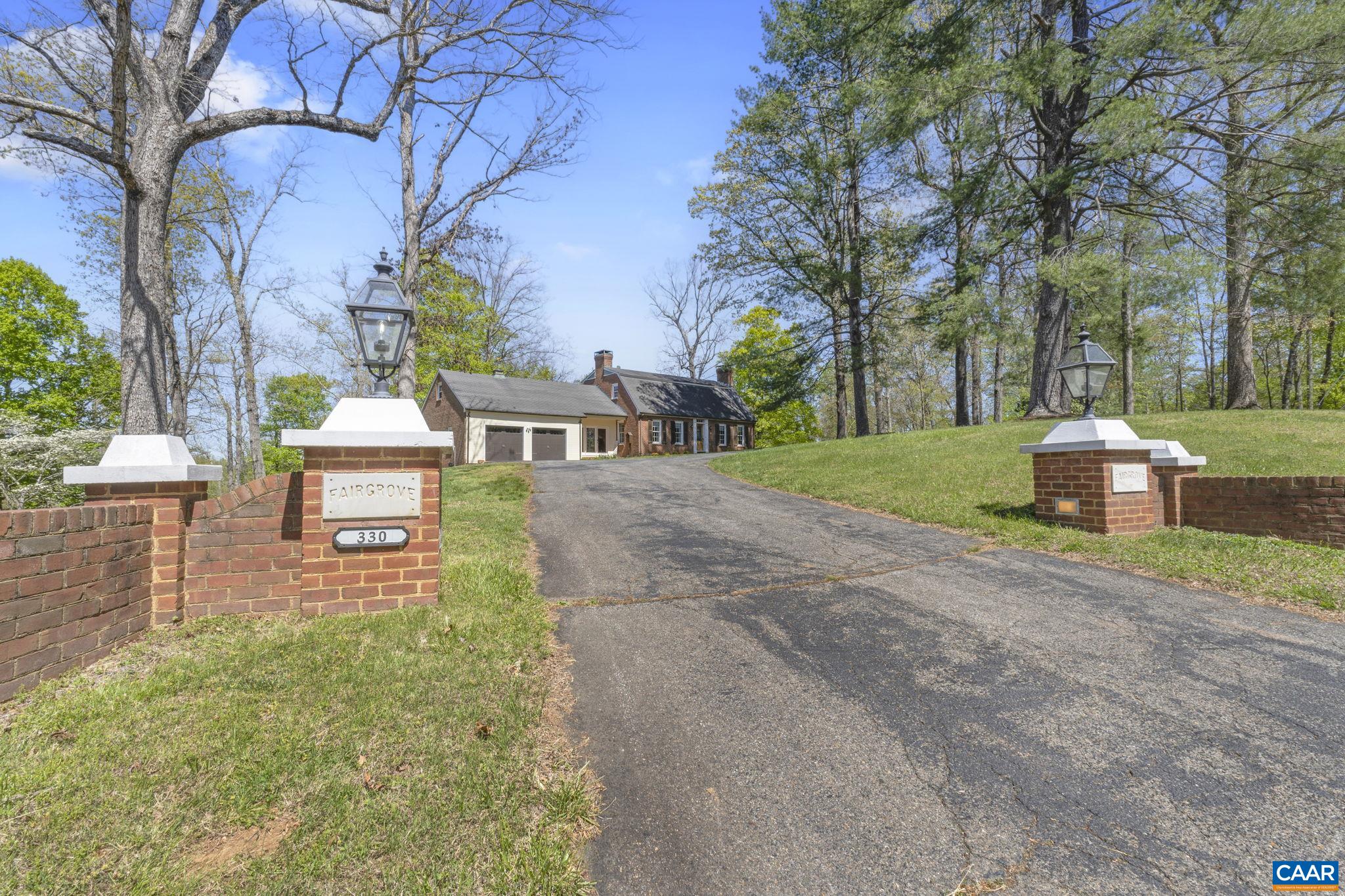 The most remarkable of finds! Nearly 12 acres of lakefront property offering a stately 5 bedroom, 3.5 bath home with terrace level apartment and situated in the centrally located Carrsbrook neighborhood. Restored, improved and tastefully updated, Fairgrove features a well appointed kitchen with tile backsplash, granite counters and a large island. Just steps away is the dining area with brick floor, fireplace and dramatic natural lighting. The lake-facing sunroom literally shines with three walls of glass, hardwood floors, vaulted ceilings and exposed beams. Included on the entry level, a gracious foyer which opens to traditional family and living rooms, a half bath, home office, mudroom and laundry as well as access to an attached garage. Upstairs are three additional bedrooms including the Primary bed and bath with fireplace as well as a full hall bath. The terrace level apartment features two additional bedrooms, a full kitchen and bath and generous living room with brick fireplace and has both an interior and private exterior entrance. Behind the home and accessed by a separate drive is an additional 3 bay garage and an open face barn and all of this perched above the woods and lake beyond.